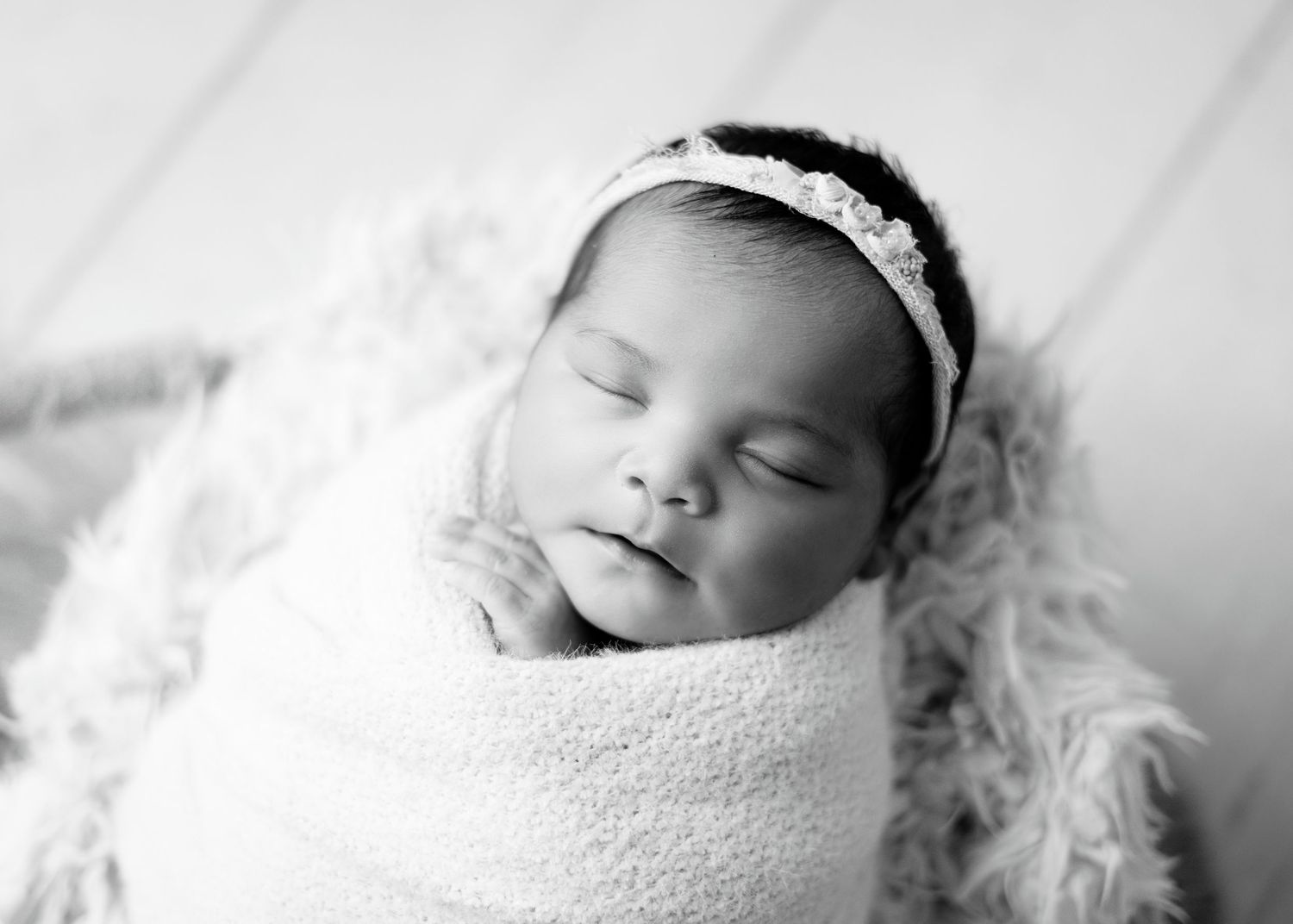 Boho Newborn girl in a basket photoshoot black and white. Boho newborn photography for newborn girls.