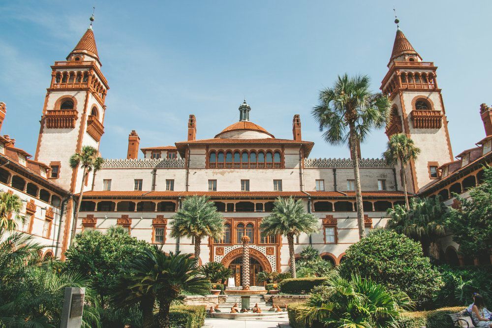 Historic Spanish Renaissance style Flagler College building with twin towers and palm trees in Saint Augustine, Florida.