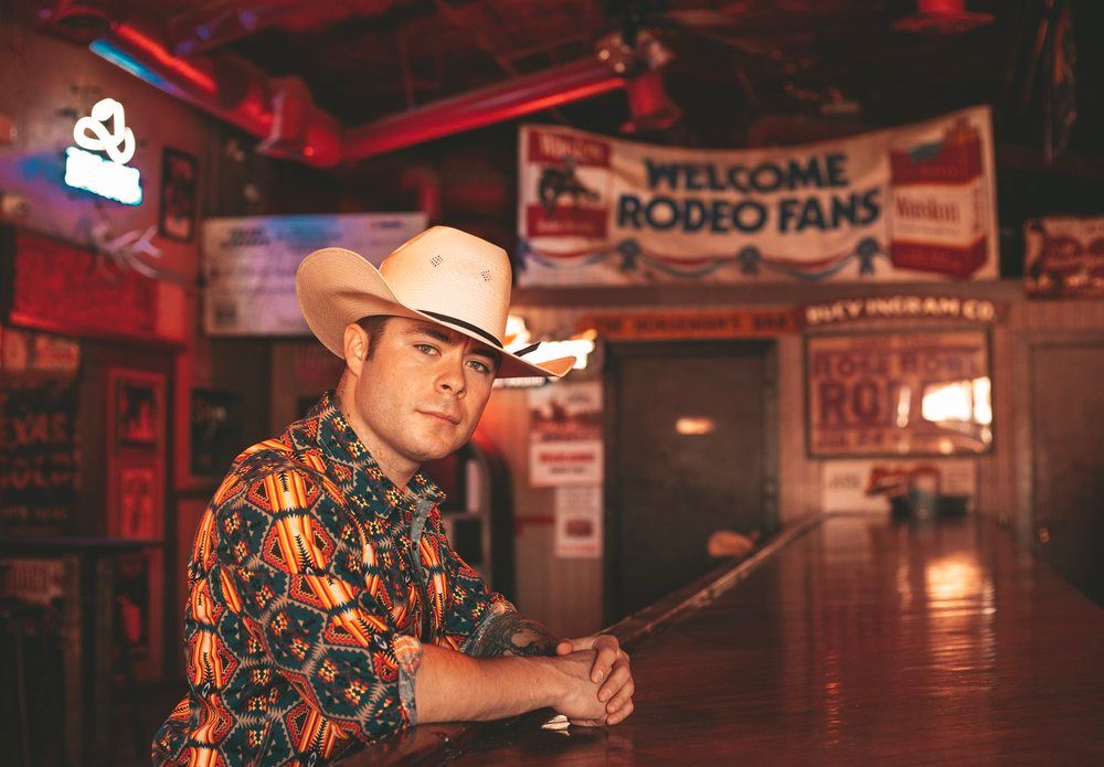 Western-themed bar interior with neon lights and rodeo decorations.