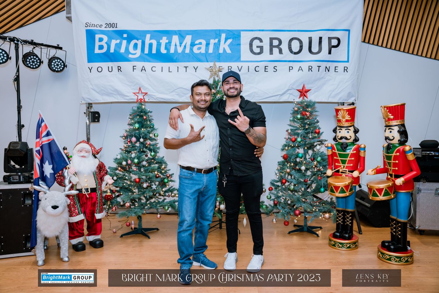 Two men posing together in front of Christmas decorations at BrightMark Group Christmas Party 2023.