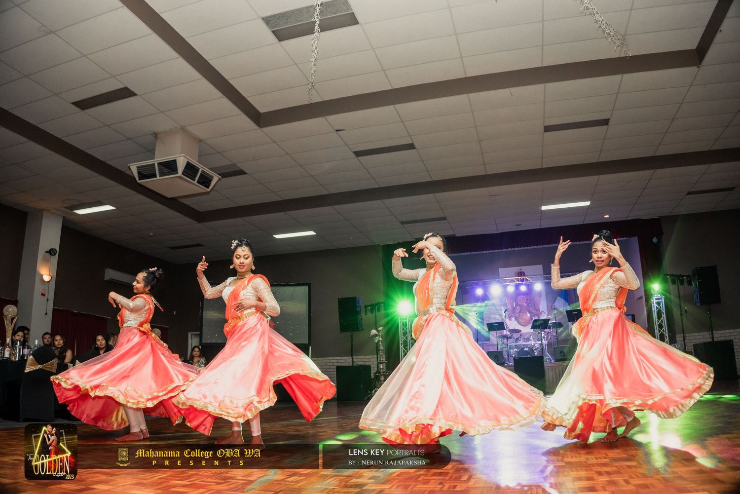 Four dancers in pink costumes performing a classical Indian dance routine at a cultural event.