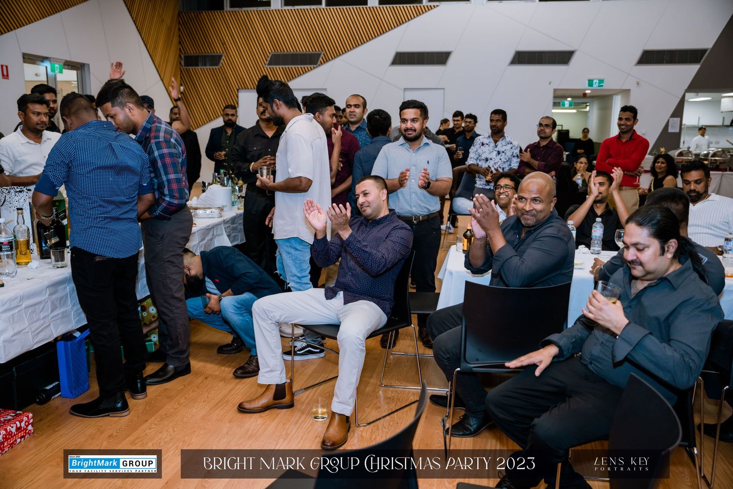 Guests laughing and celebrating at BrightMark Group Christmas Party 2023 in a festive indoor venue.