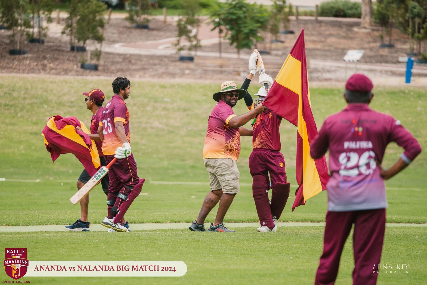 Cricket players carrying colorful flags on field during Ananda vs Nalanda Big Match 2014.