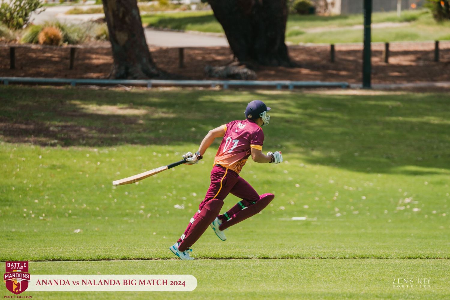 Cricket player in maroon uniform running between wickets during Ananda vs Nalanda Big Match 2014.