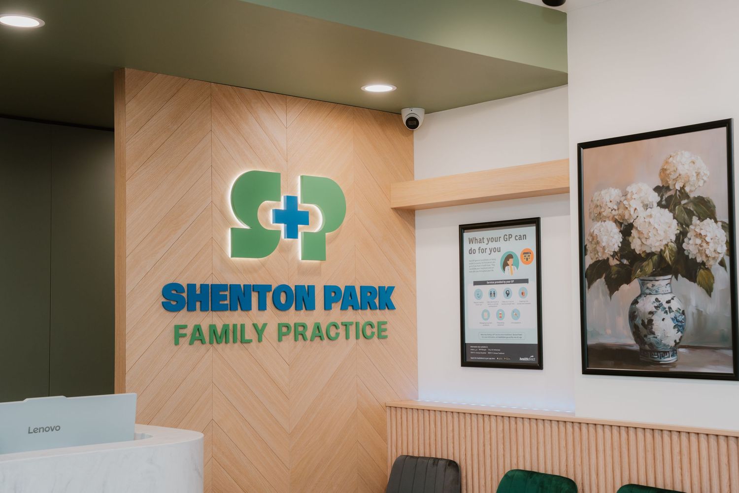 Shenton Park Family Practice logo on wooden wall panel in a clean waiting area.