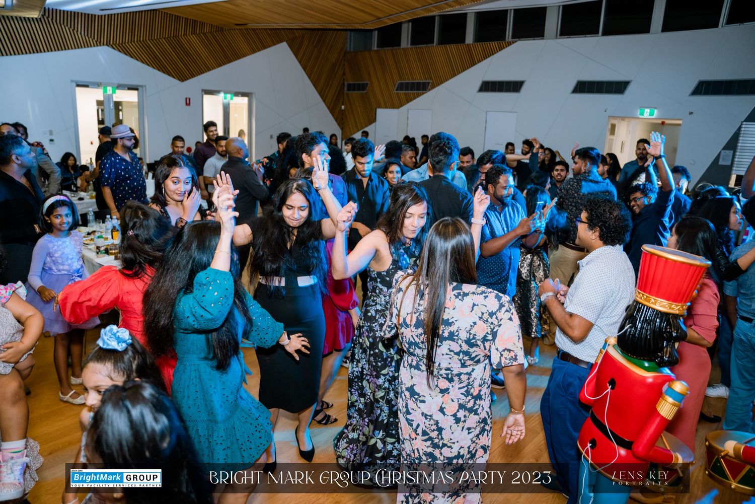 Crowd of guests dancing and celebrating at BrightMark Group Christmas Party 2023 indoor venue.