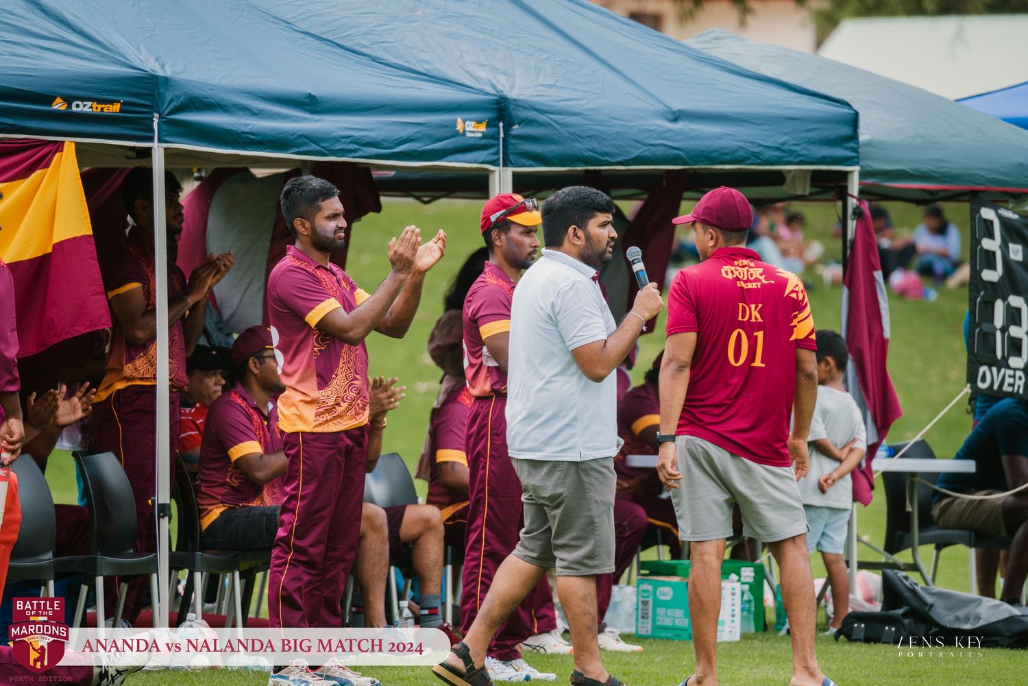 Cricket team members in maroon uniforms gathered under tent during Ananda vs Nalanda Big Match 2014.