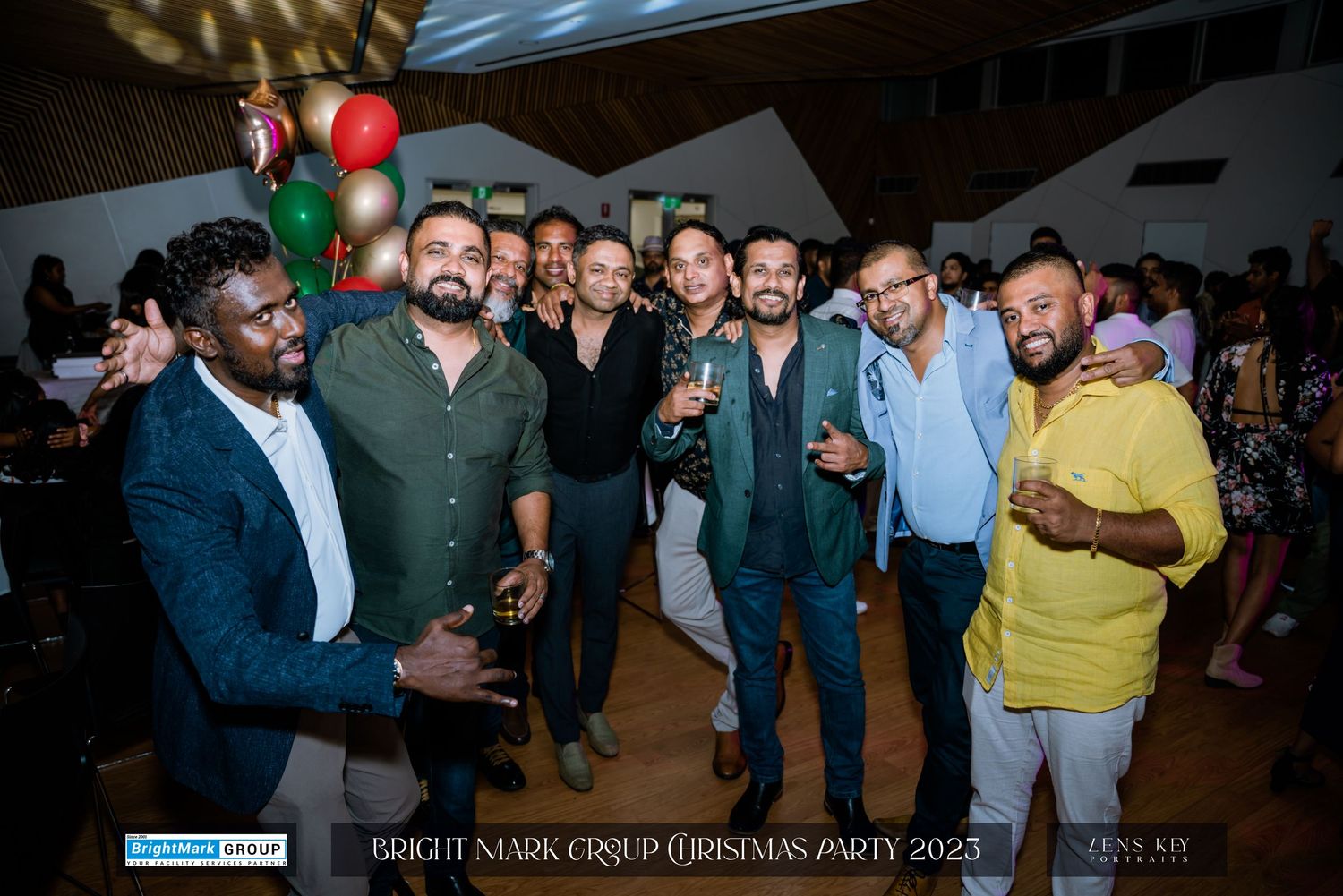 Group of men smiling and posing together at BrightMark Group Christmas Party 2023 celebration.