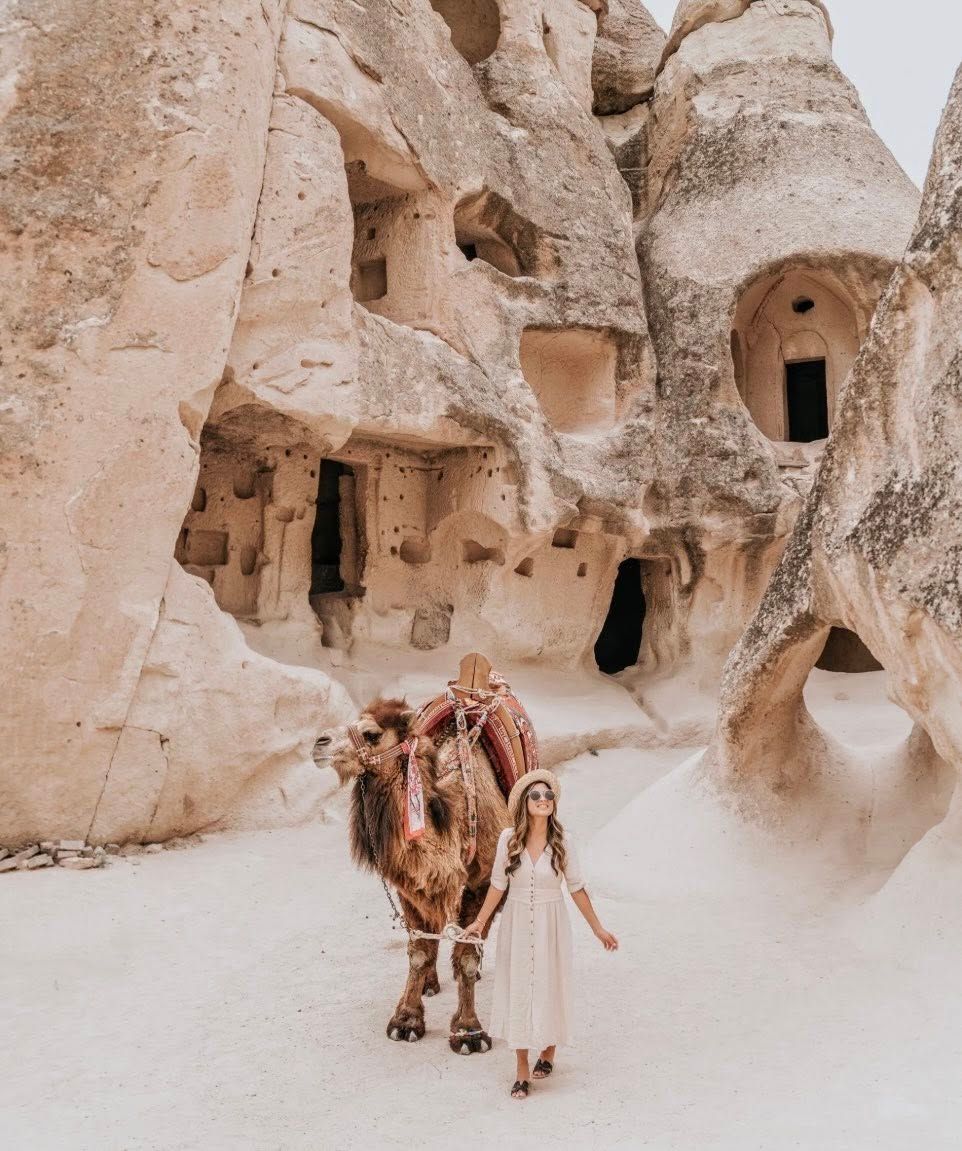 Ancient cave dwellings carved into white rock formations in Cappadocia.