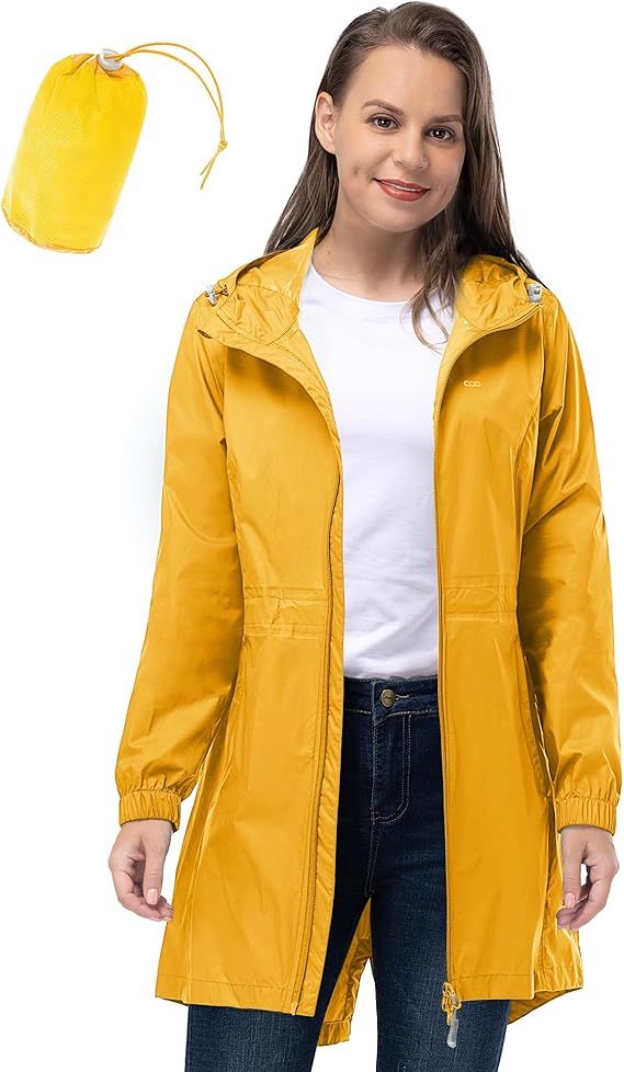 A lightweight yellow raincoat with a matching pouch worn with blue jeans and a white t-shirt against white background.