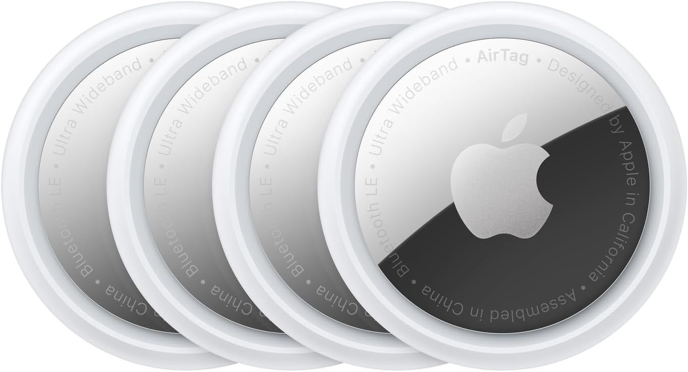 Multiple stacked Apple AirTags tracking devices shown in white and gray with Apple logo design.