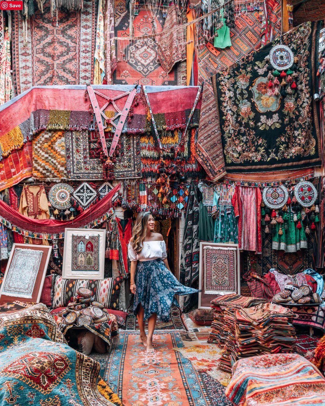 Vibrant Turkish bazaar displaying colorful carpets, textiles and traditional decorative items.