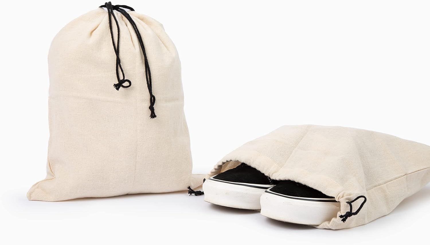 Canvas drawstring shoes bags in natural beige color with black pull cords, perfect for storage and travel.