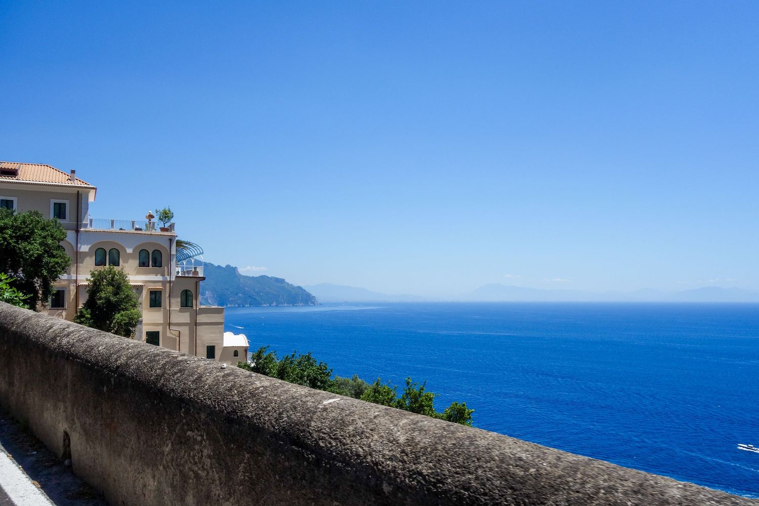 Stunning panoramic view of the Mediterranean coastline with mountains meeting crystal blue waters.