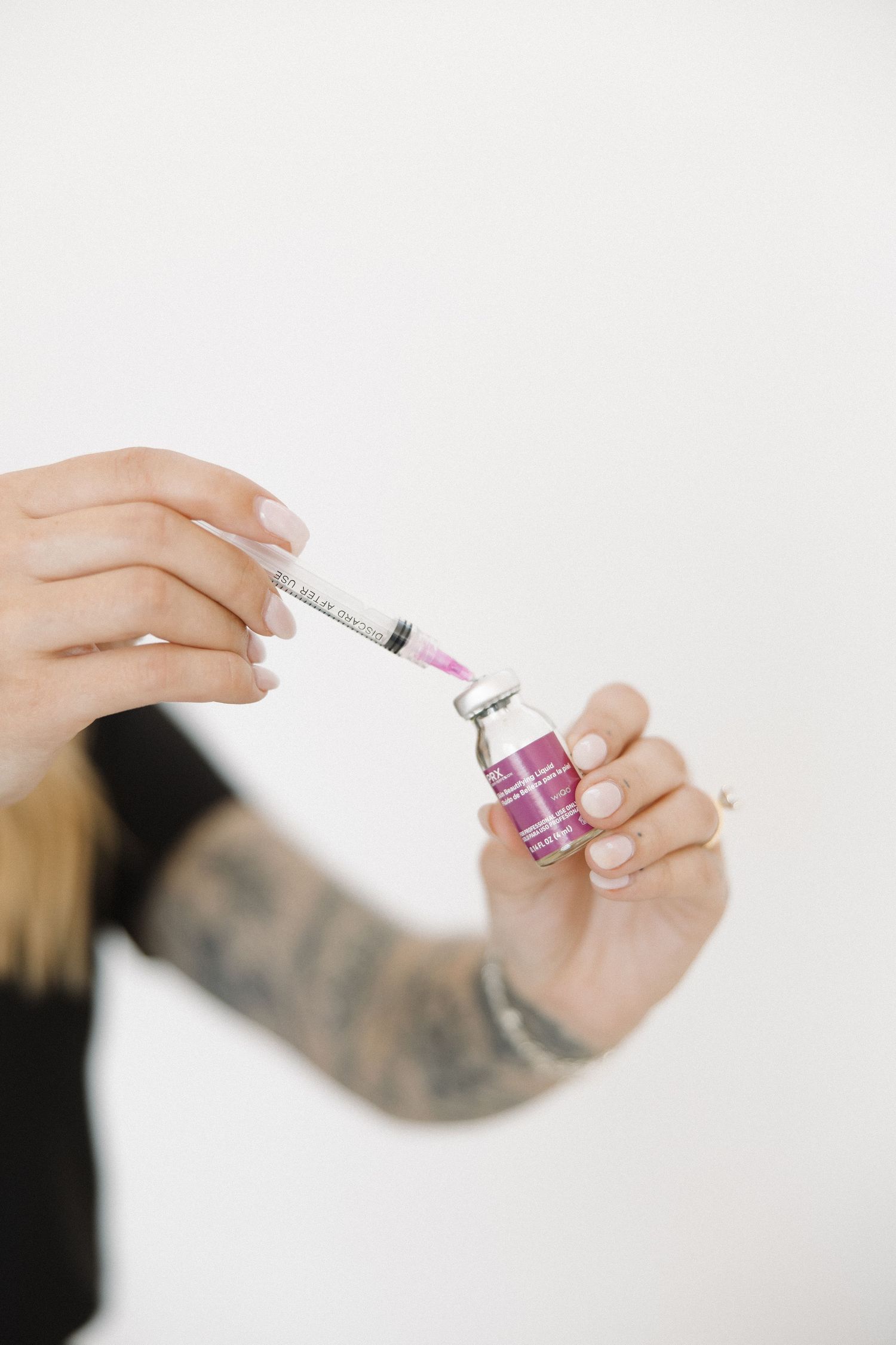 Close-up of hands applying beauty product with precise technique.