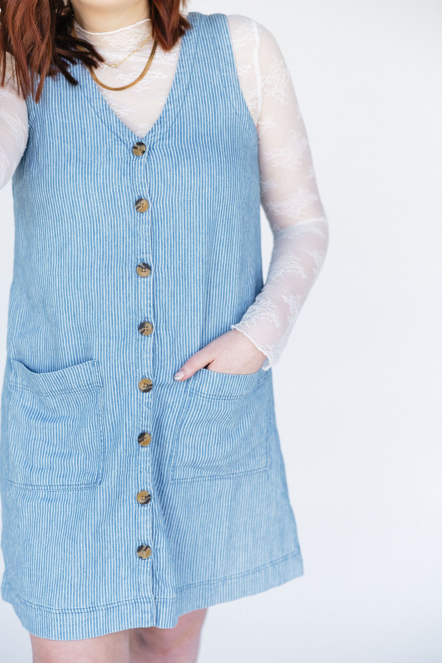 Light blue corduroy button-front vest with pockets shown against white background.