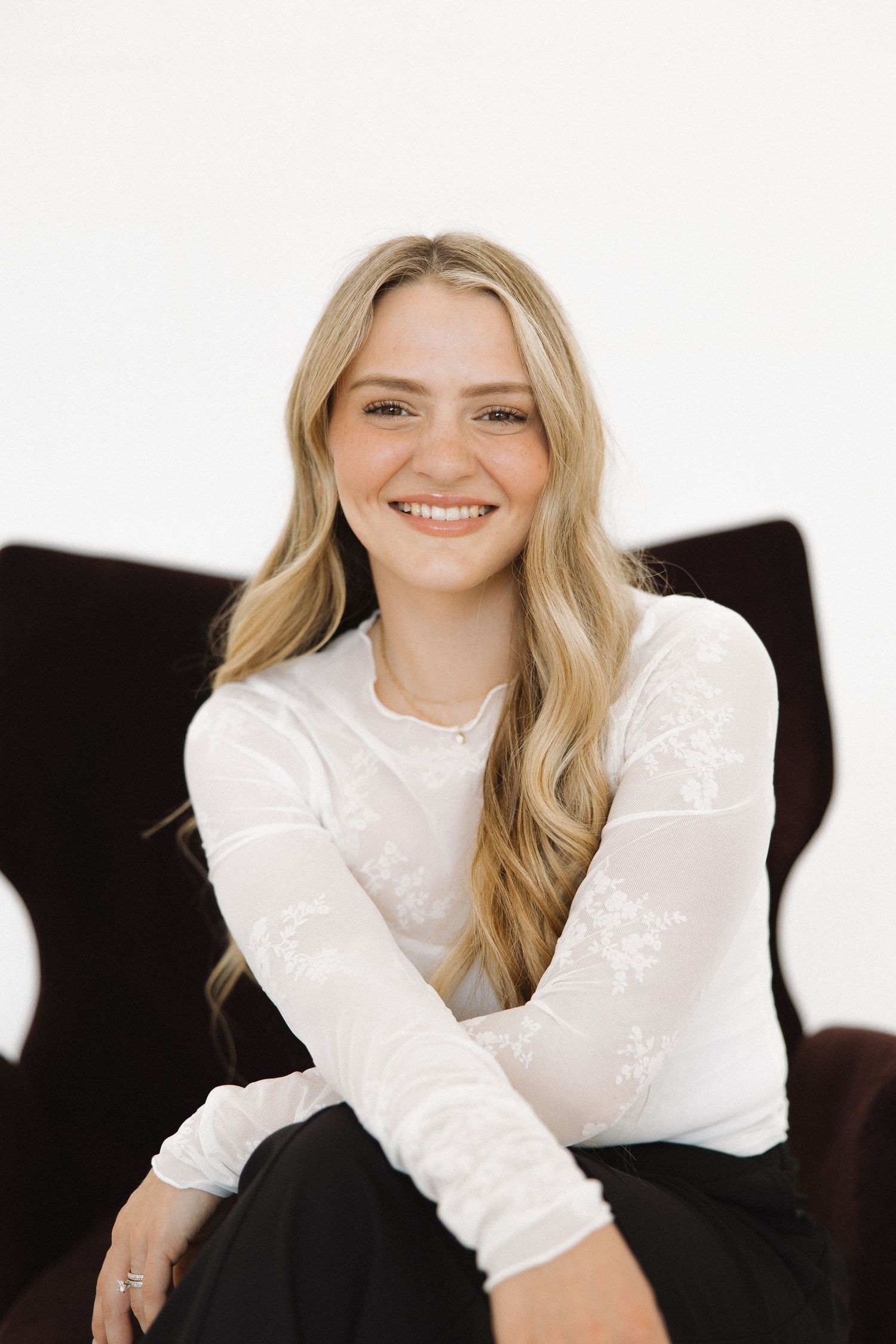 Studio portrait series featuring bright expressions and classic black and white styling.
