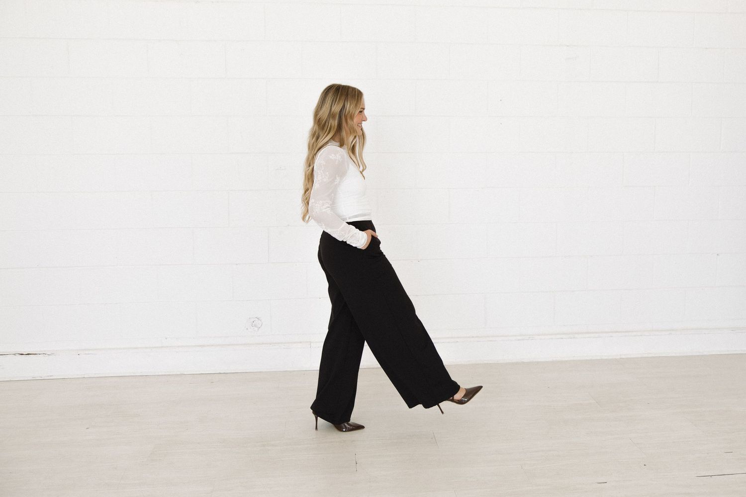Dynamic full body shots showing movement and walking poses in minimalist white studio space.