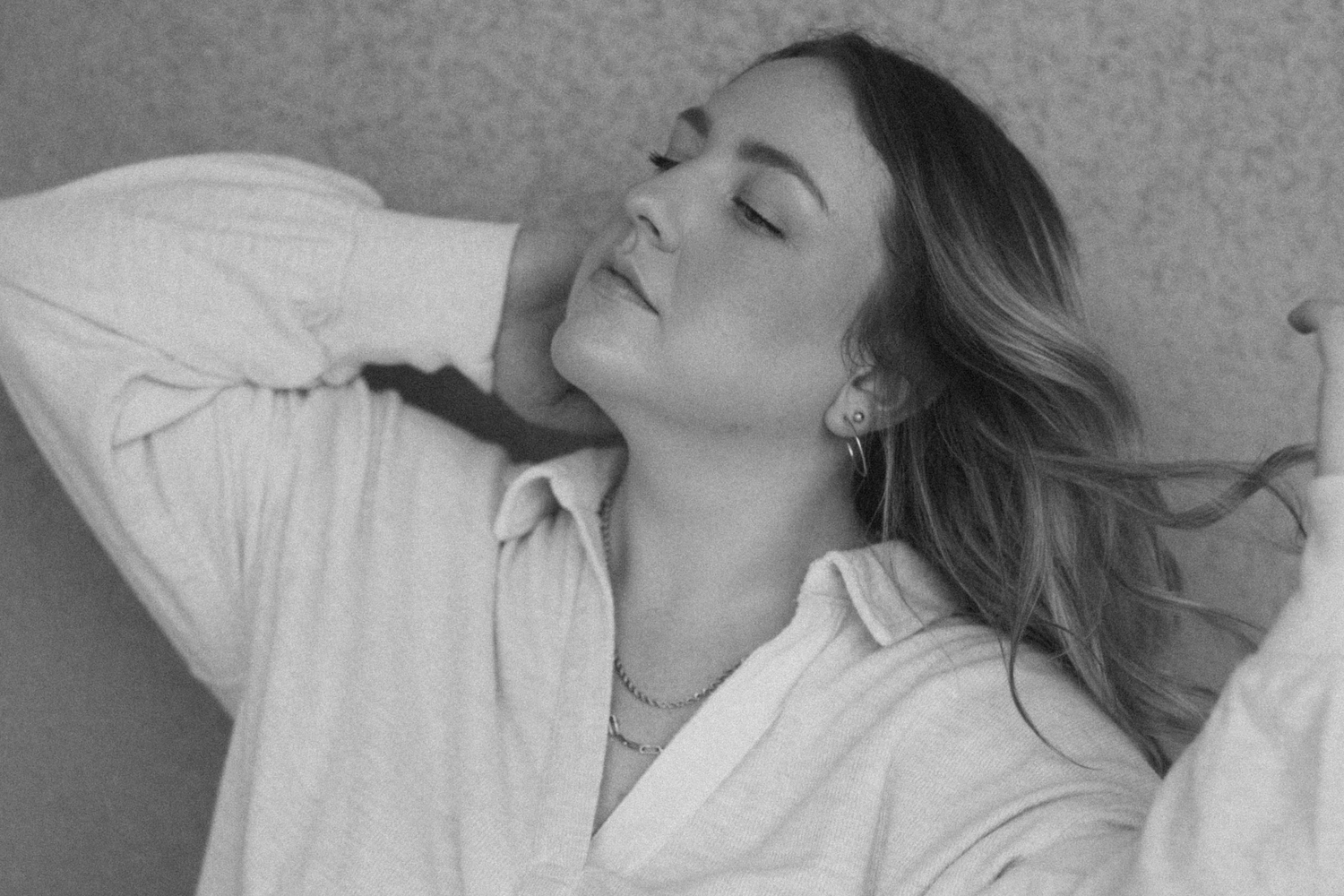 Black and white portraits showing contemplative poses against a neutral background.