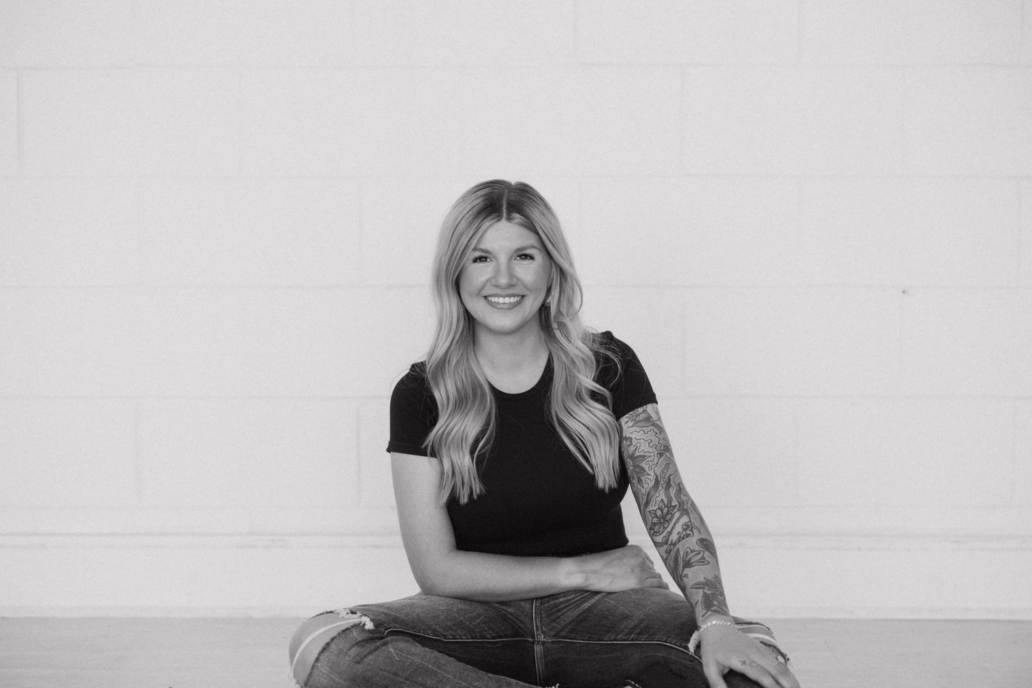 Black and white casual portrait against light background.