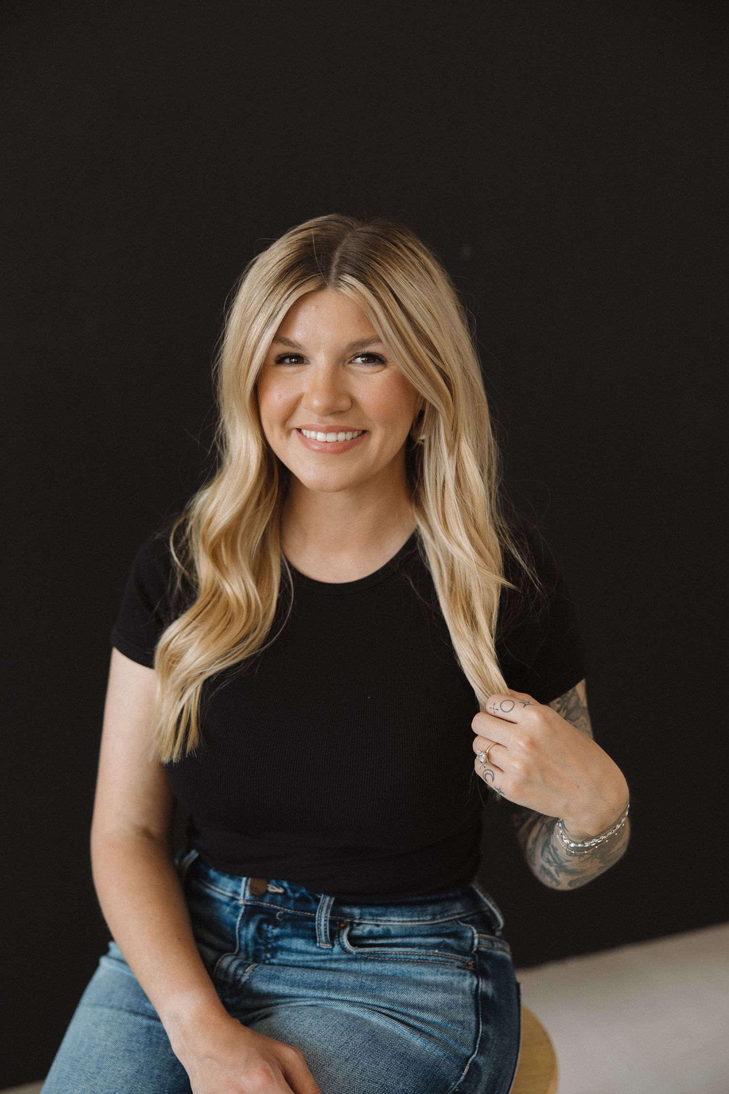 Lifestyle portrait against dark background showing casual style.