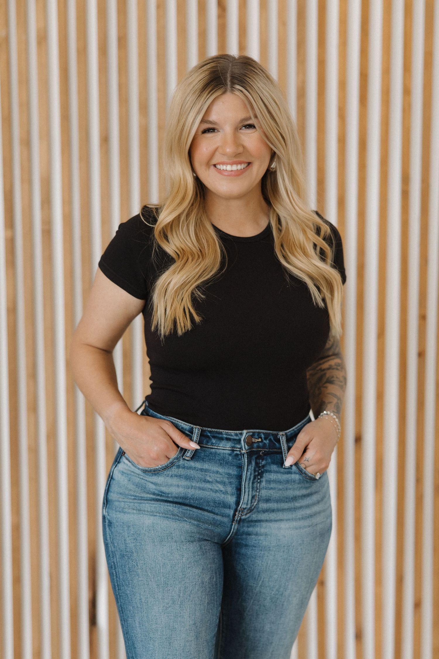 Casual fashion portrait against wooden slat background.
