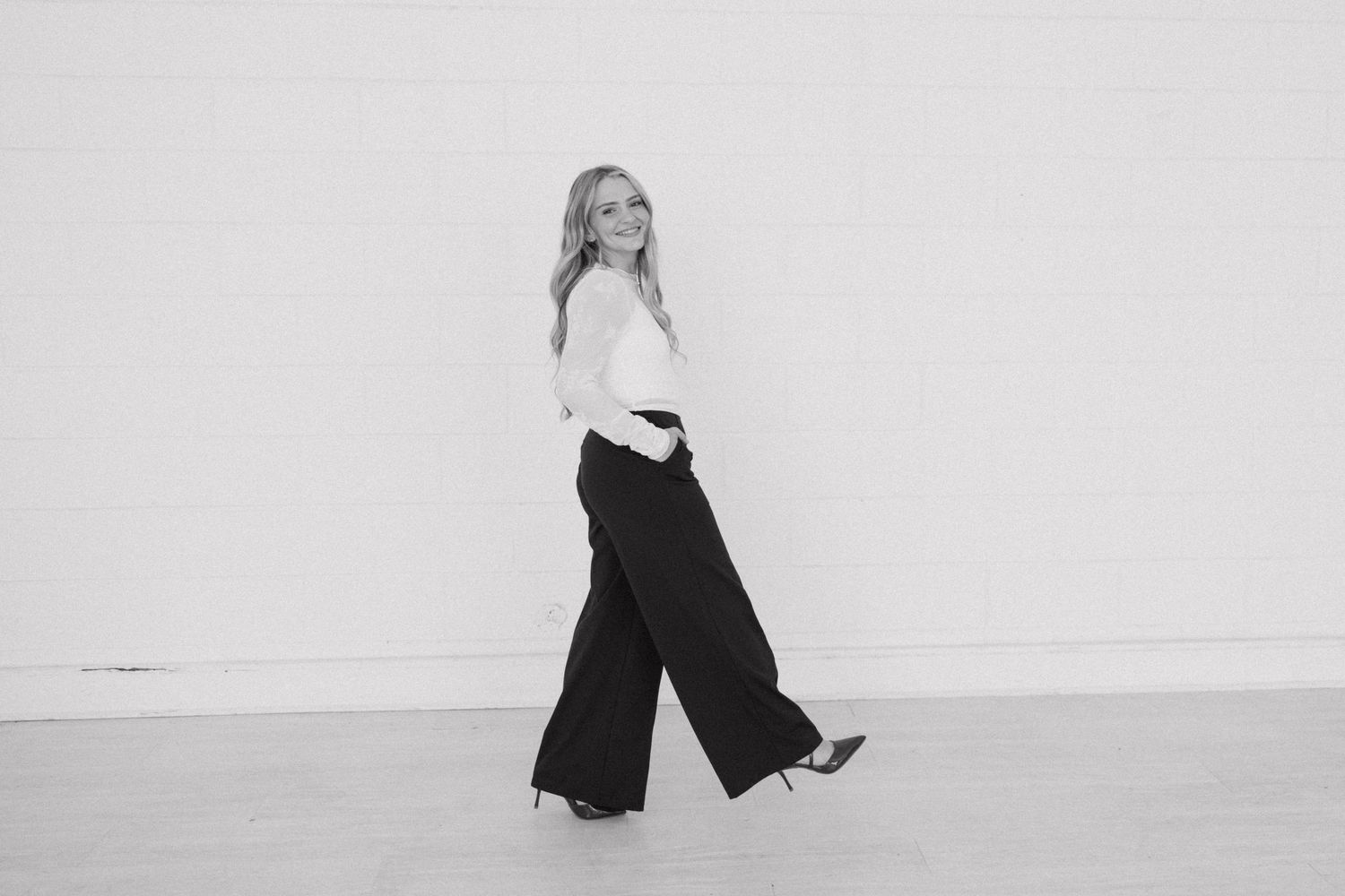 Artistic black and white motion portraits showing movement and dance-like poses in studio setting.