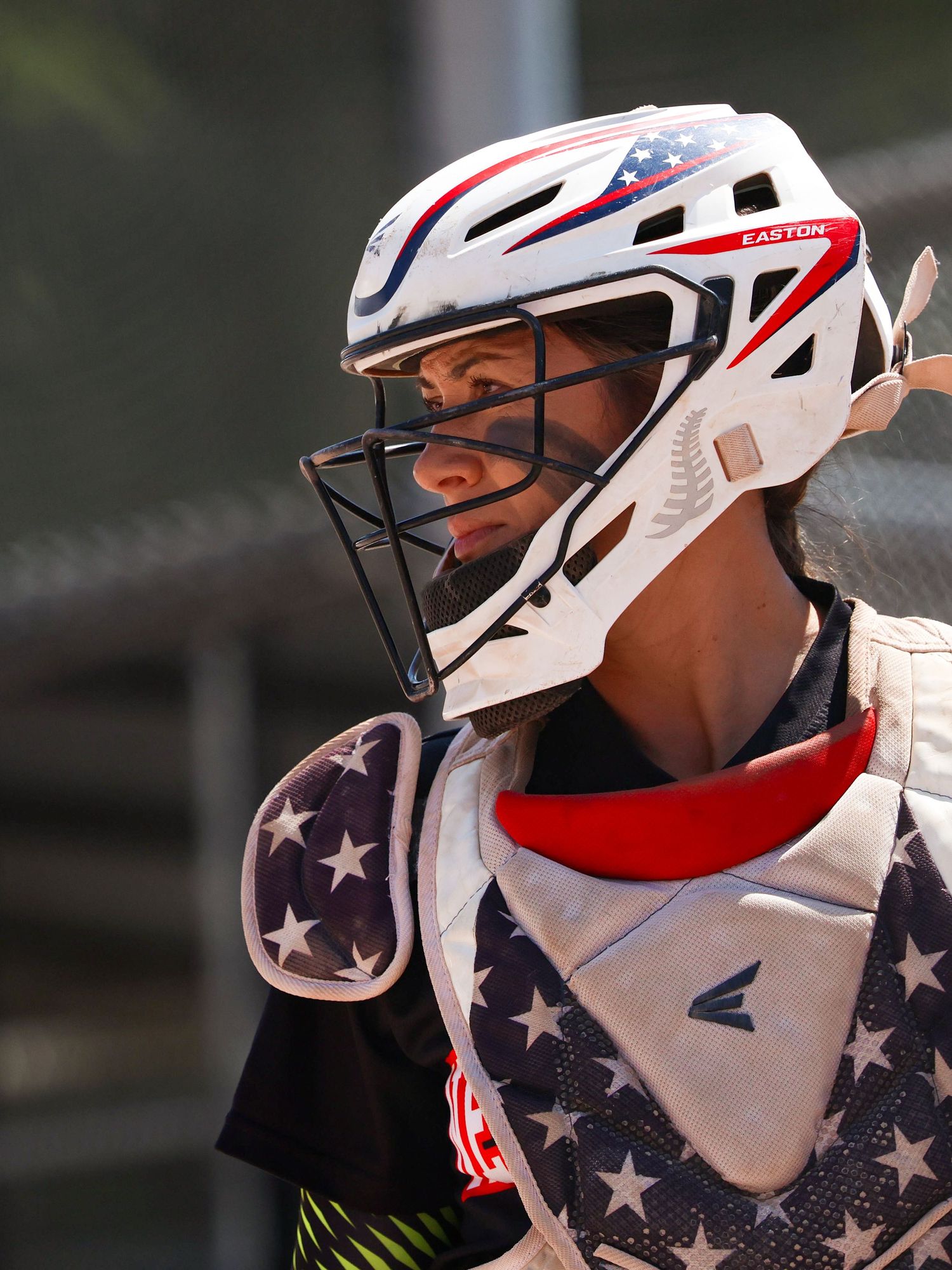 Baseball catcher in Easton patriotic stars and stripes gear with helmet and chest protector.