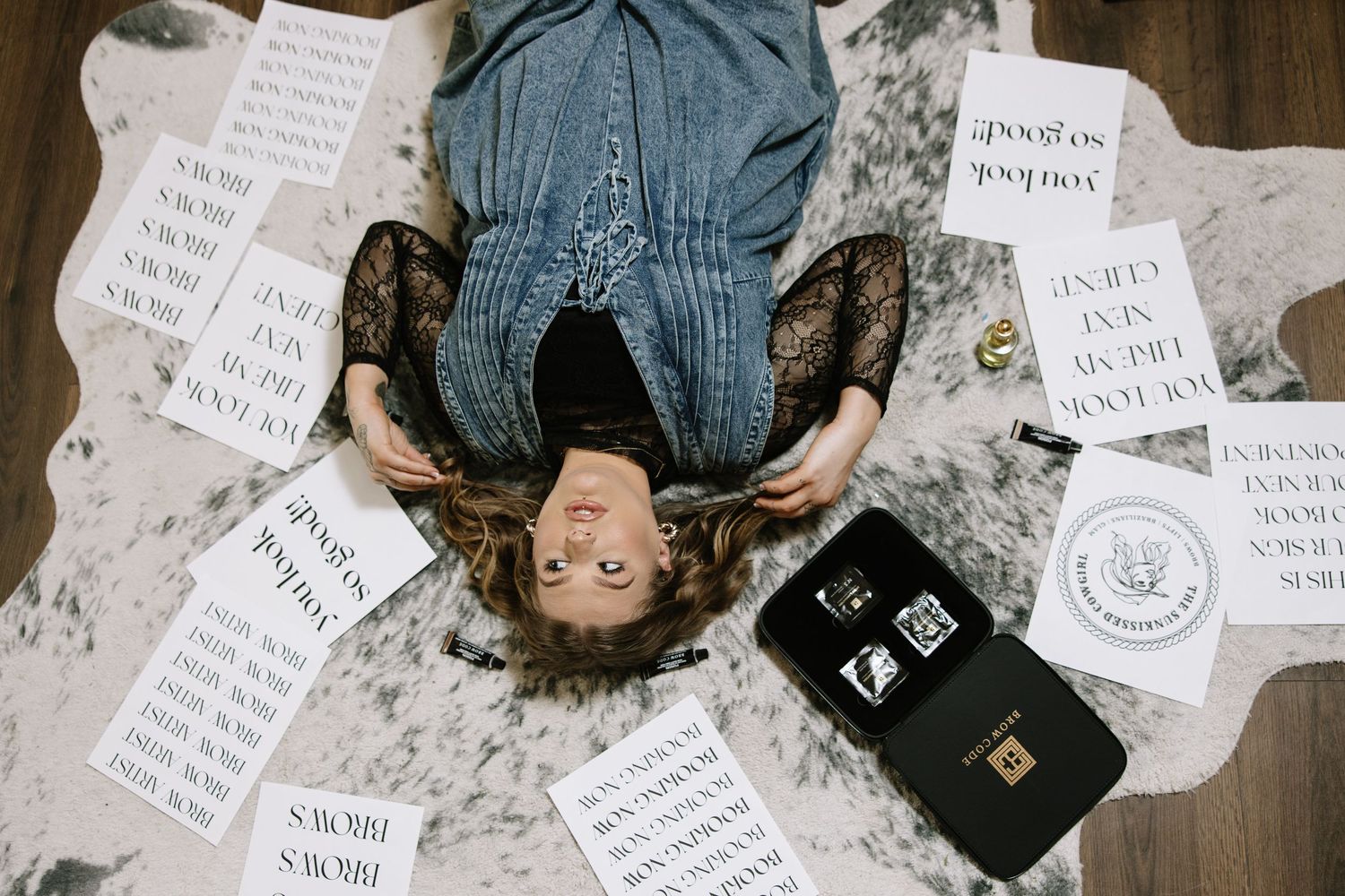 Overhead view of scattered paper notes and documents on wooden floor.
