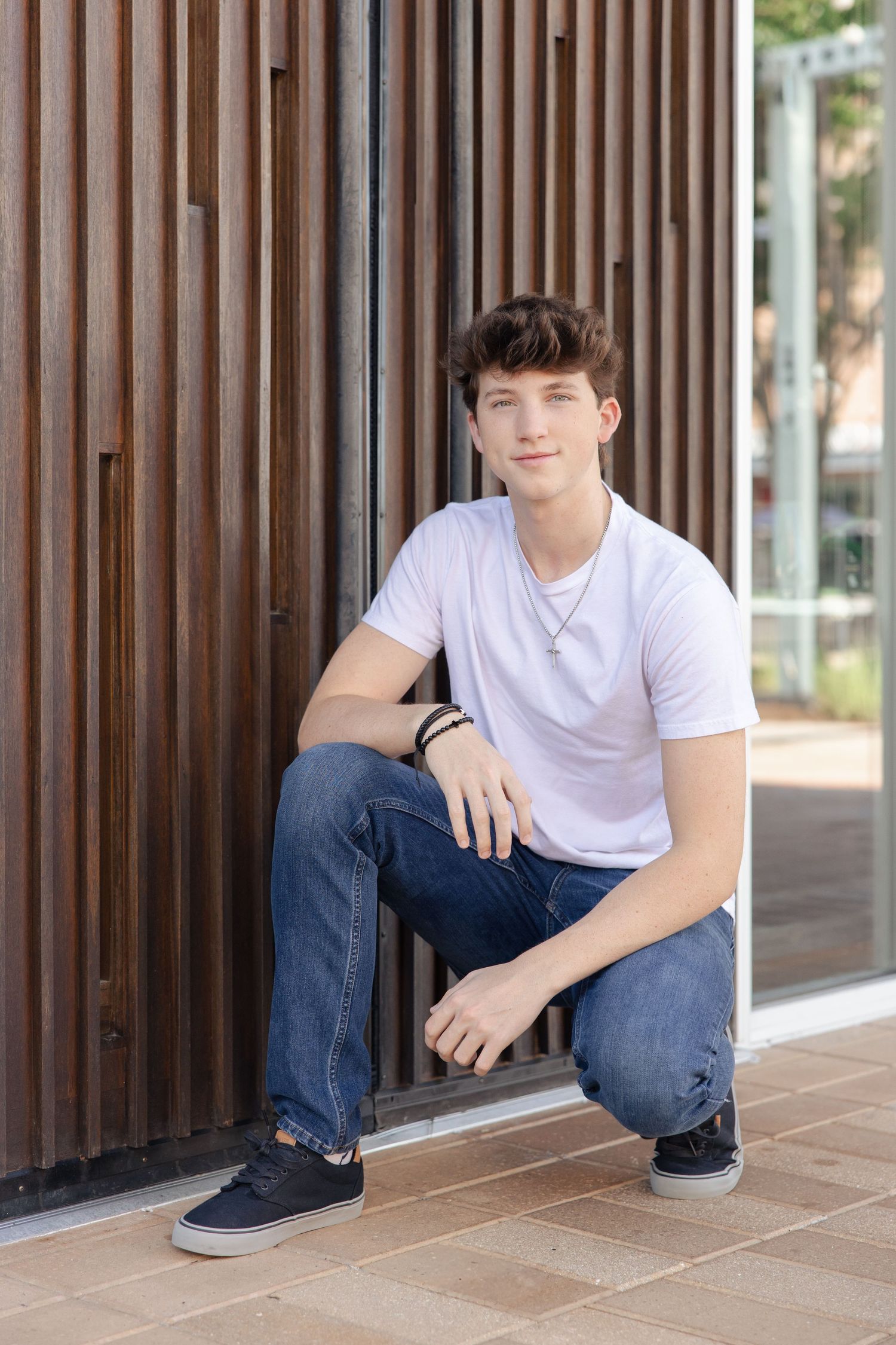 Casual portrait series against wooden slat wall in an urban setting.