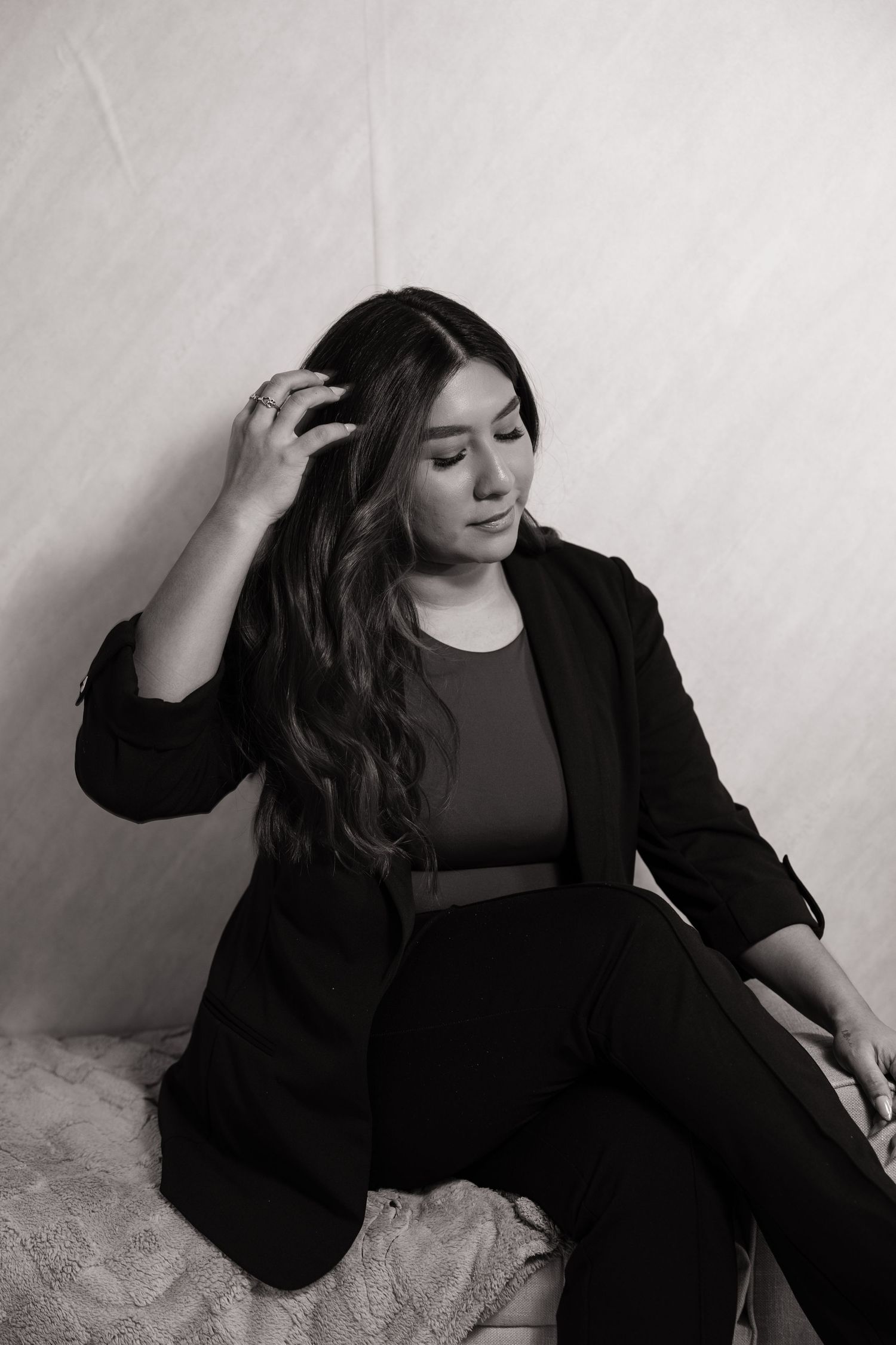 A series of artistic black and white portraits showing a person in dark clothing against a light background.