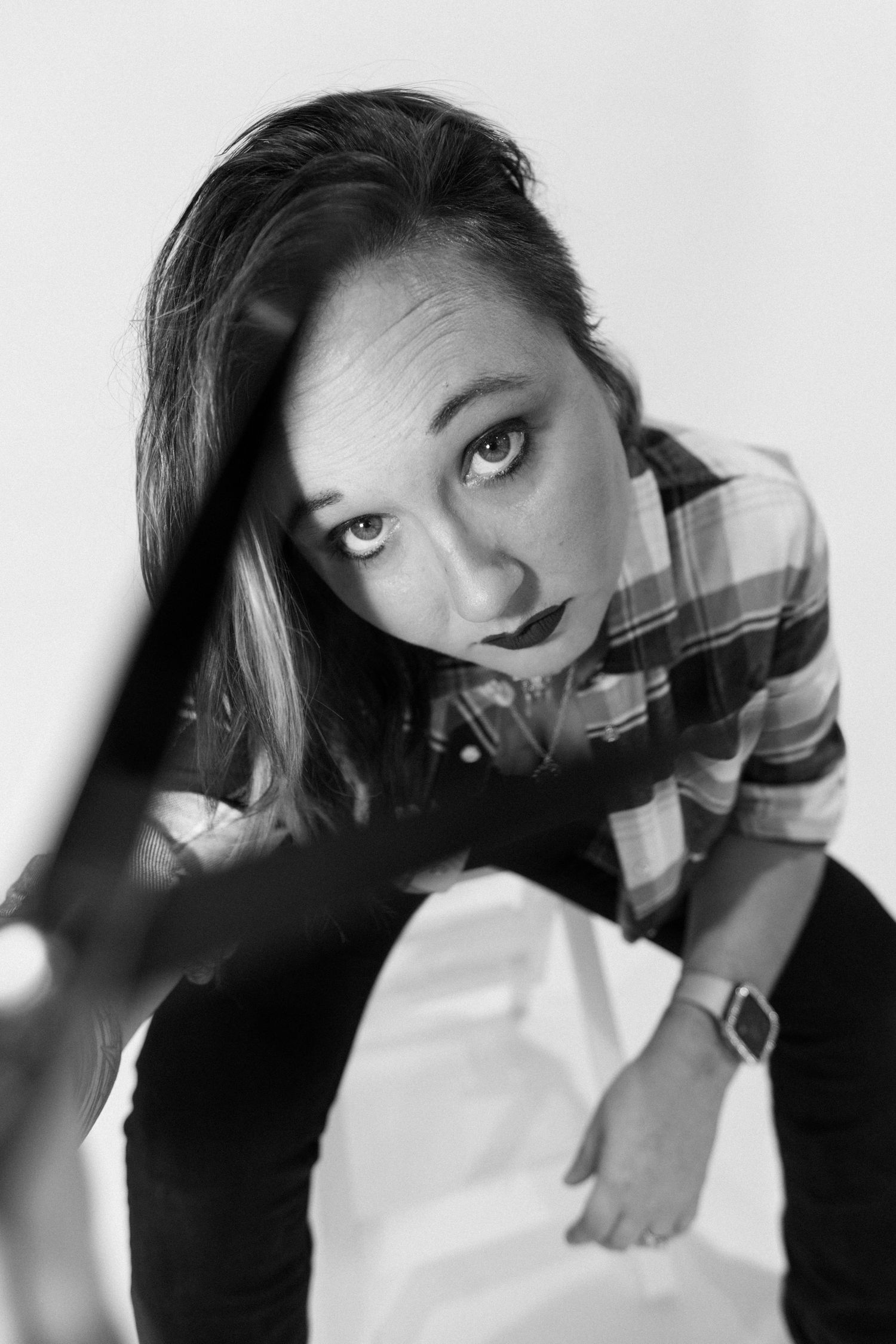 Artistic black and white portrait series showing dramatic angles and expressions.