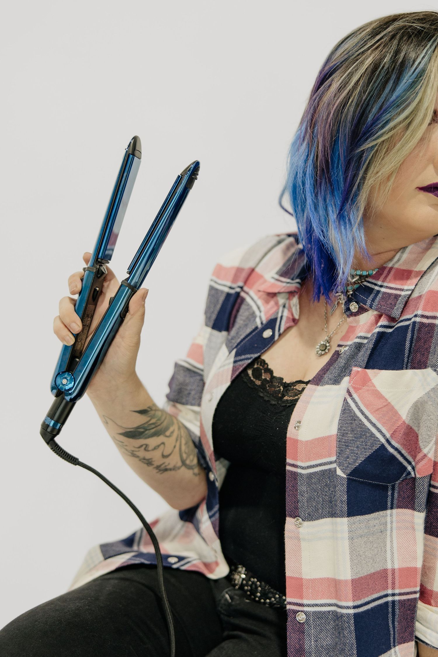 Close-up shots of blue hair and styling tools against gray background.