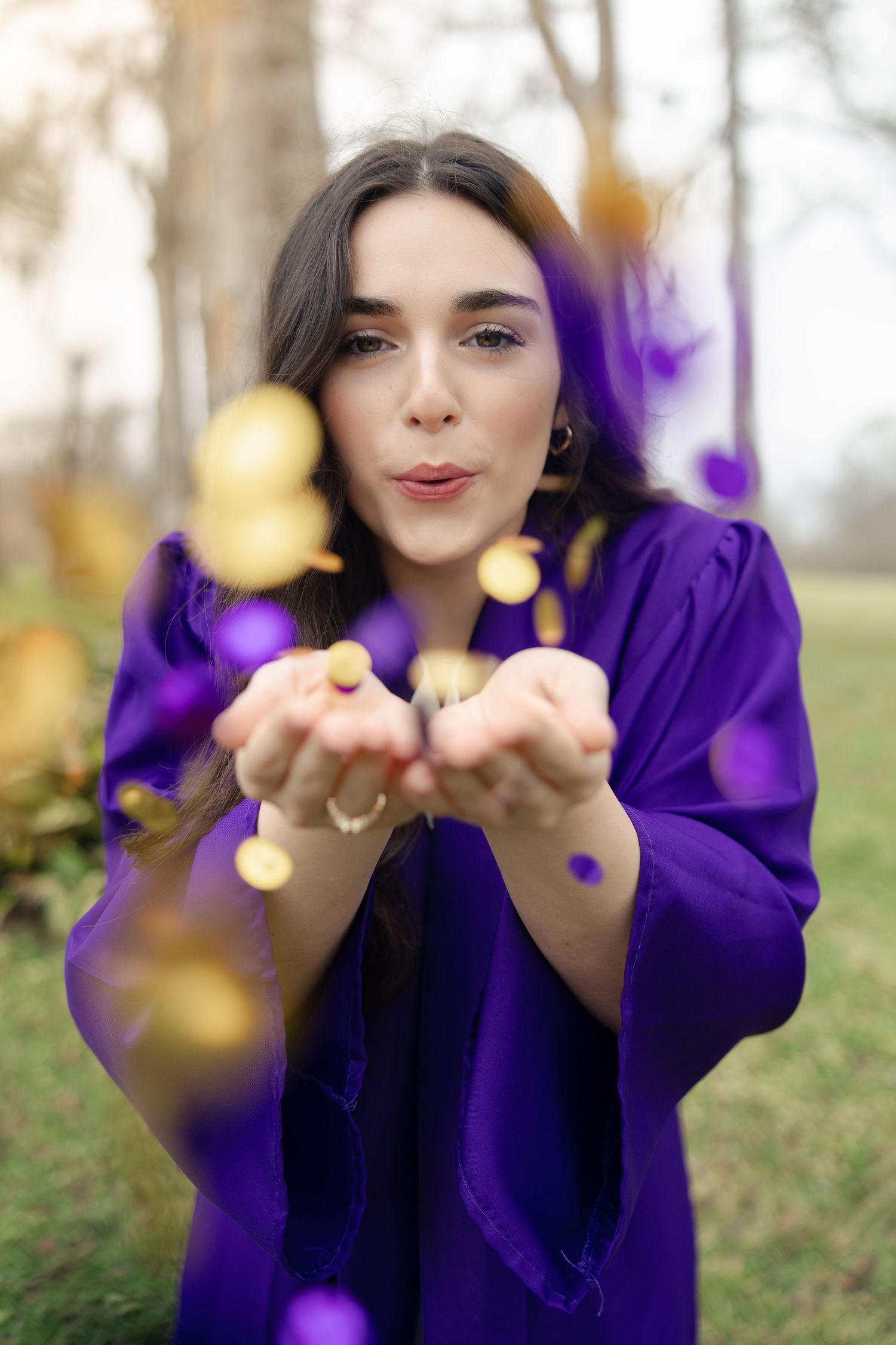 A sequence showing hands tossing golden glitter against a purple background.