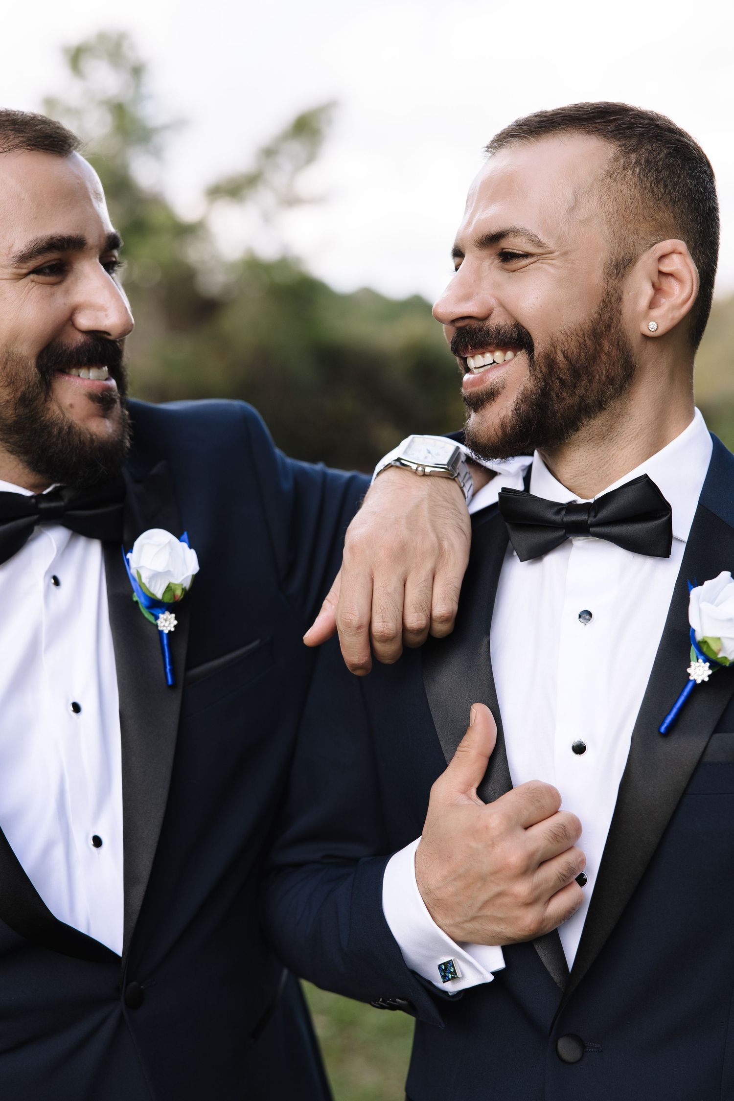 A series of candid wedding photos showing groomsmen in black tuxedos and bow ties sharing joyful moments together.