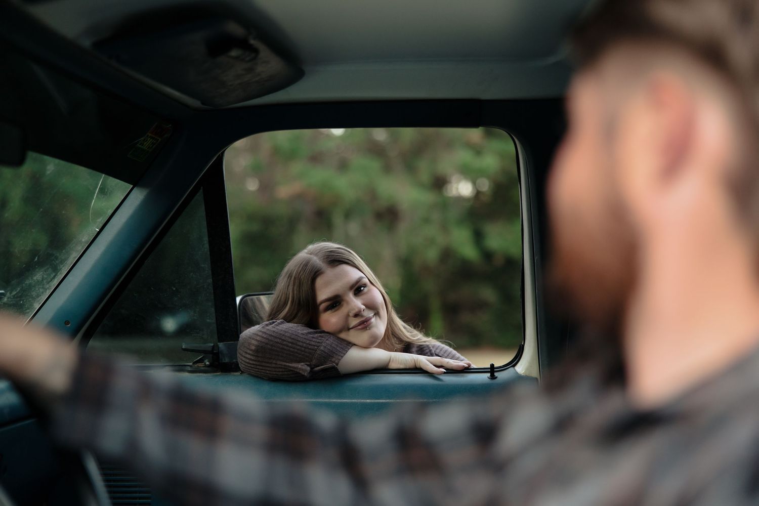 A series of photos showing someone driving a car and looking out the window while in motion.