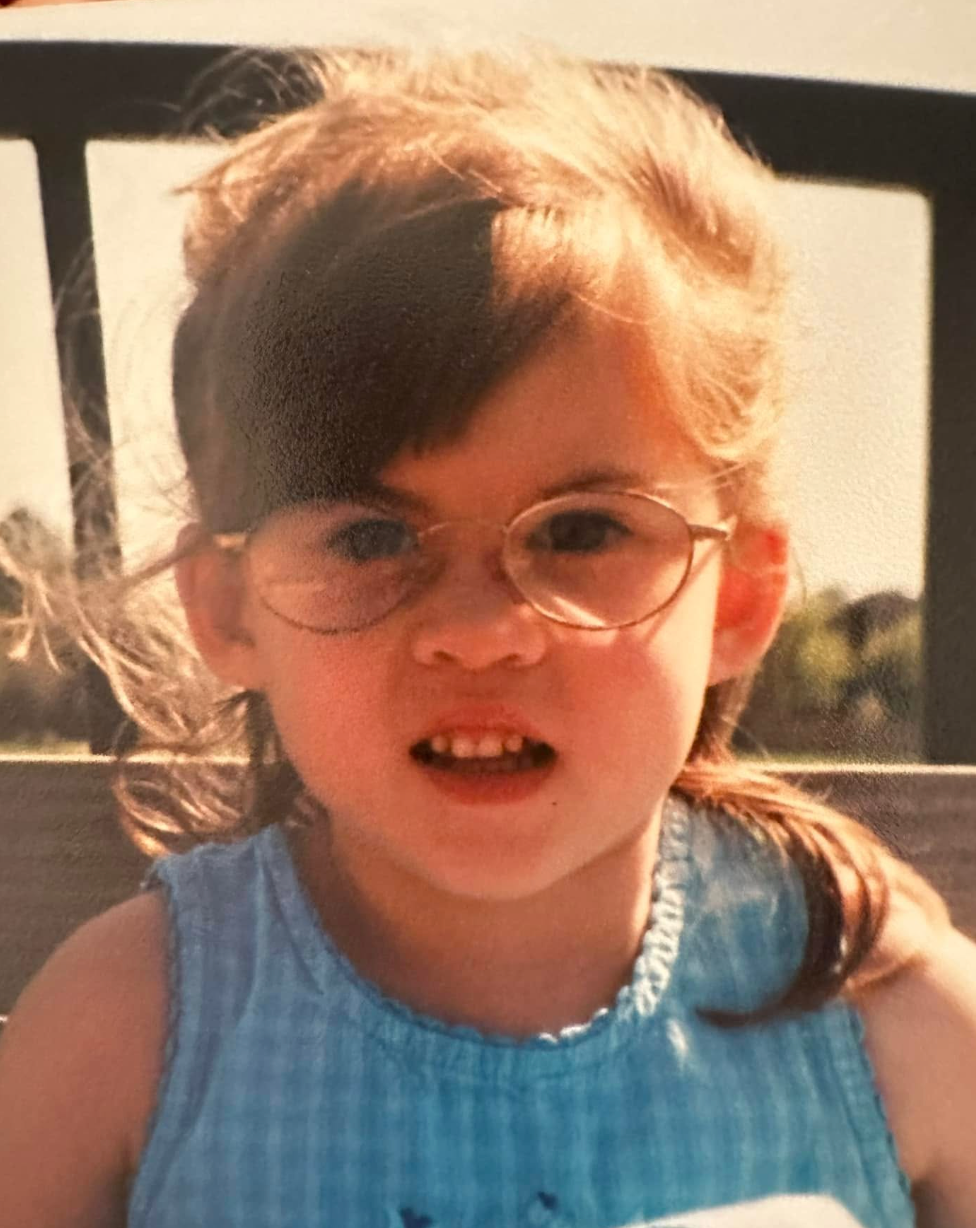 A young child in a blue gingham dress smiling and laughing in vintage-style photos.