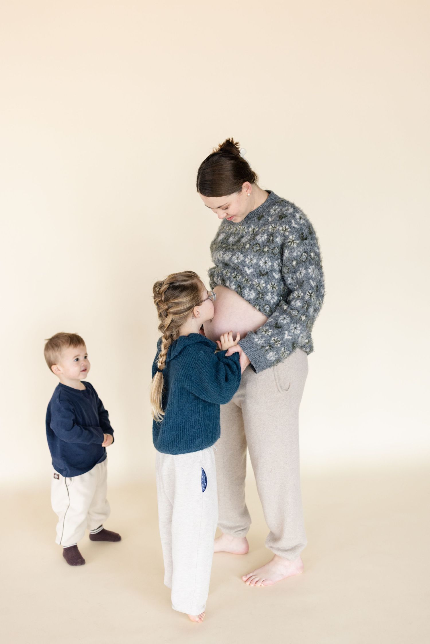 Four sequential photos show a military service member in uniform interacting with a small child in a navy shirt.