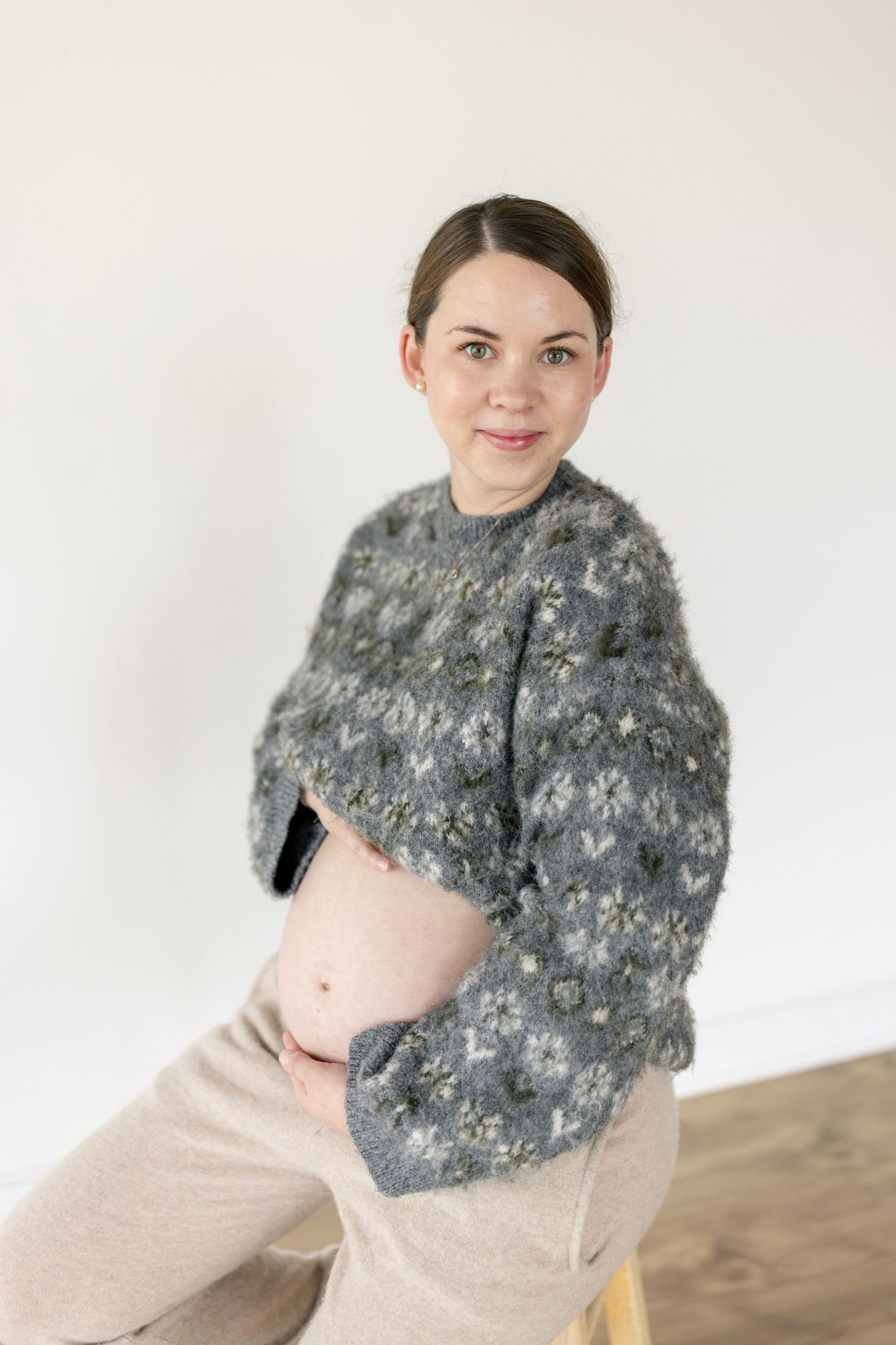 A cozy gray knit winter scarf with a textured pattern is displayed in multiple styling positions against a light background.