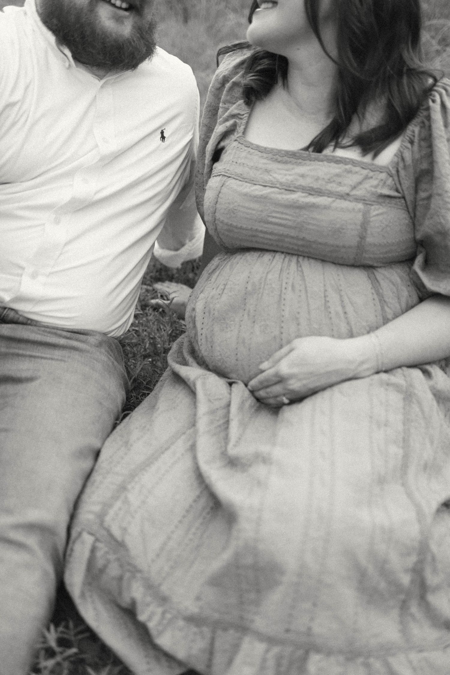 Black and white sequence capturing tender moments between expectant parents.