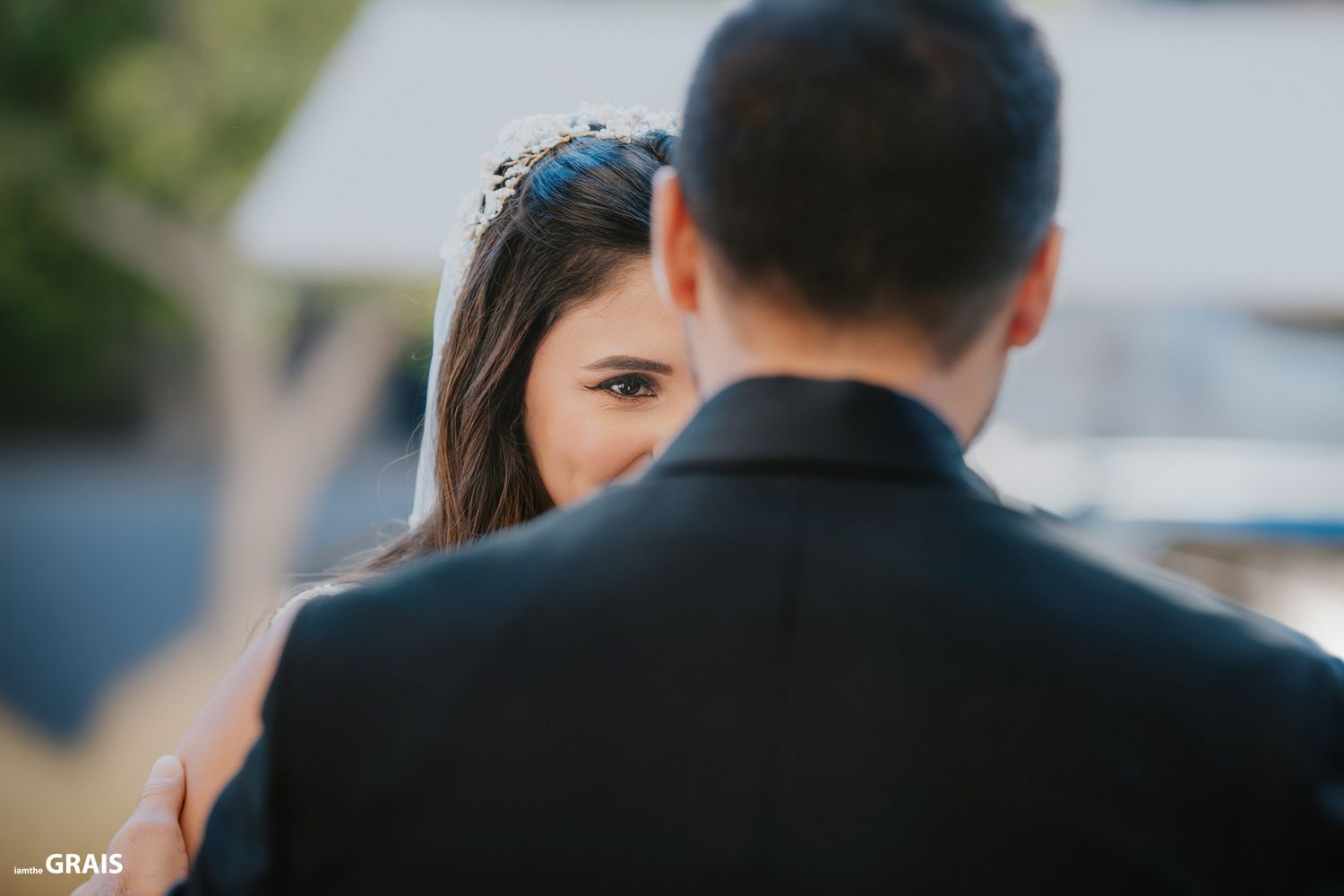 A close up profile shot of a bride with her partner during an outdoor ceremony.
