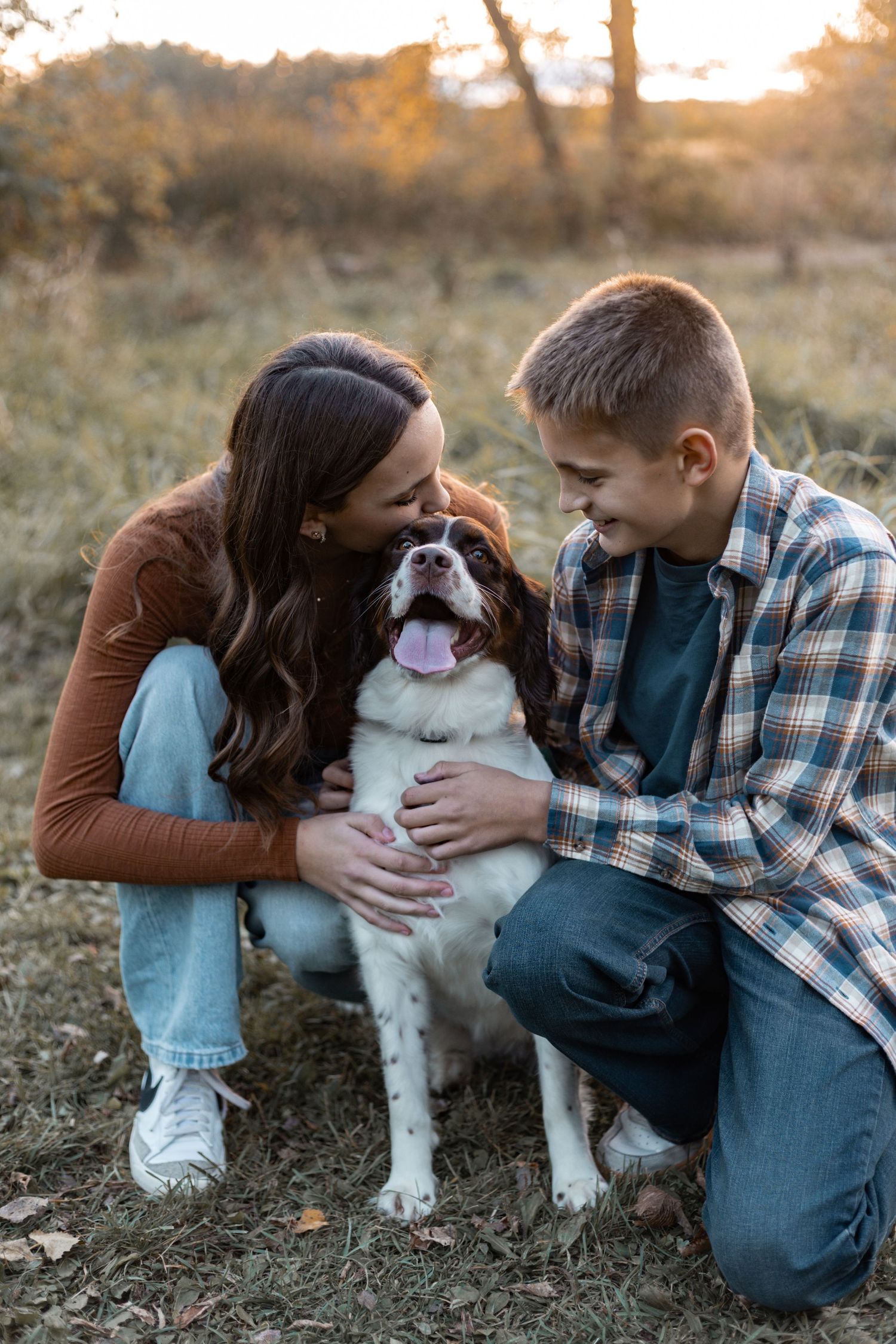 Lakeville family photographer capturing playful family moment at sunset