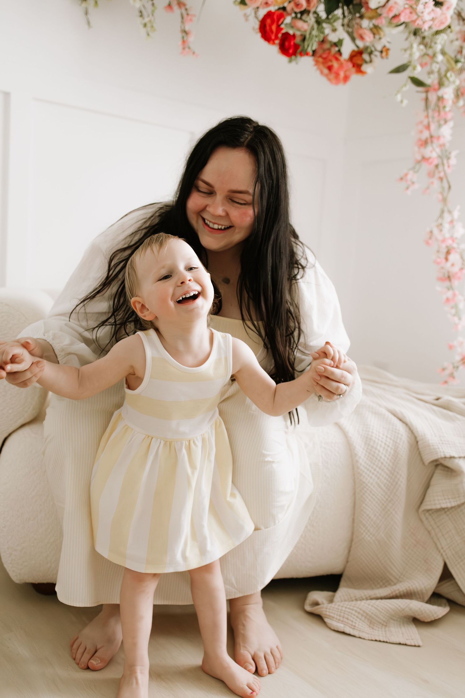 A laughing mother and baby girl share a joyful moment during motherhood mini session in Lakeville