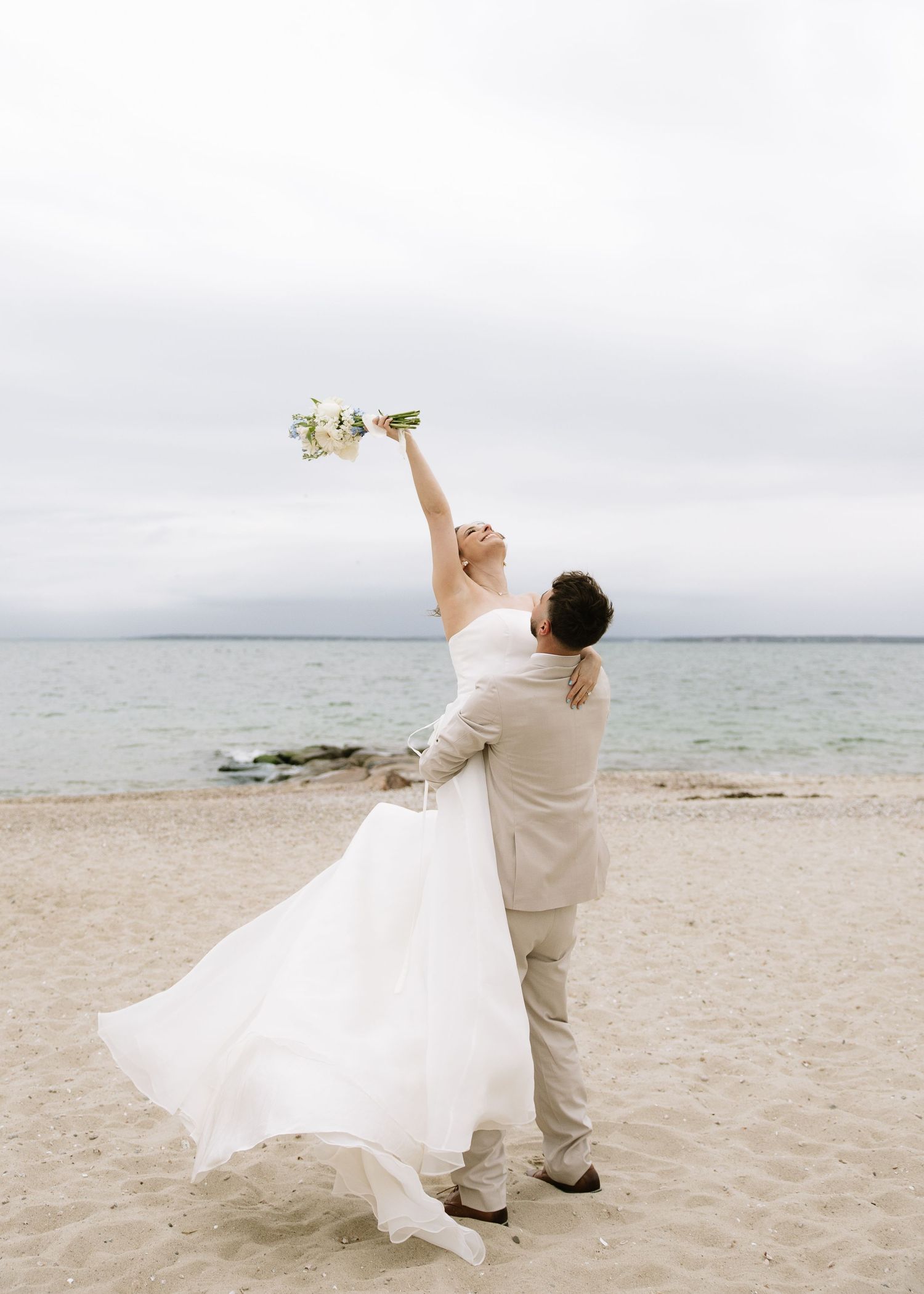 Groom holding bride on Cape Cod coastal elopement
