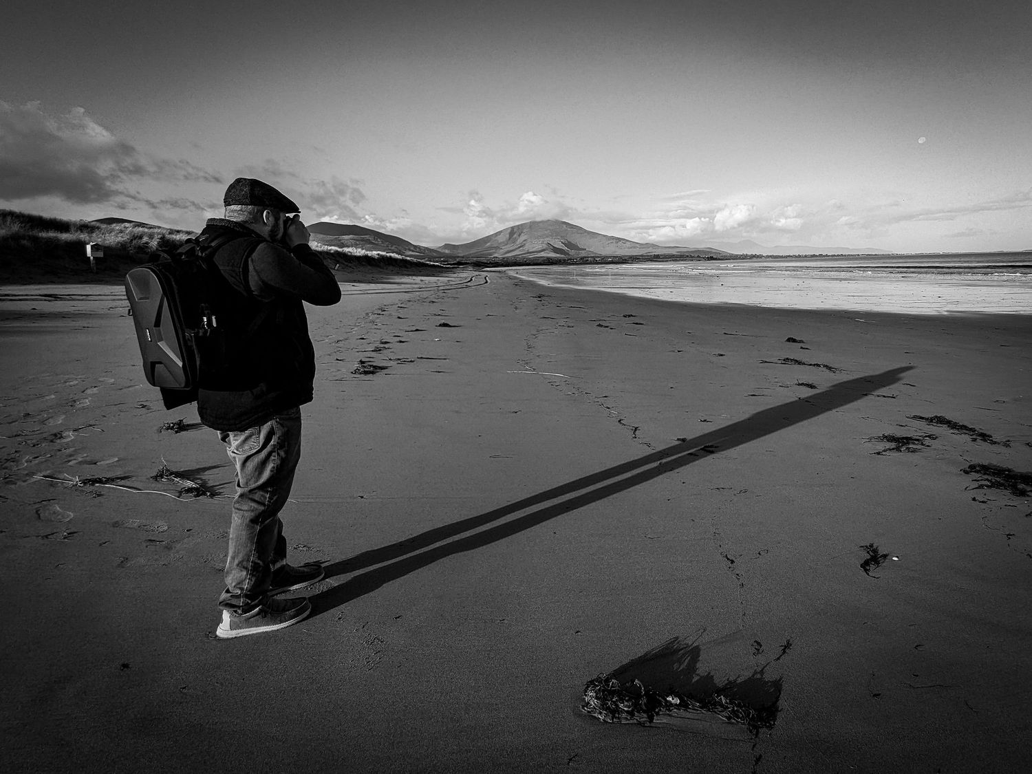 A photographer on a beach in Ireland