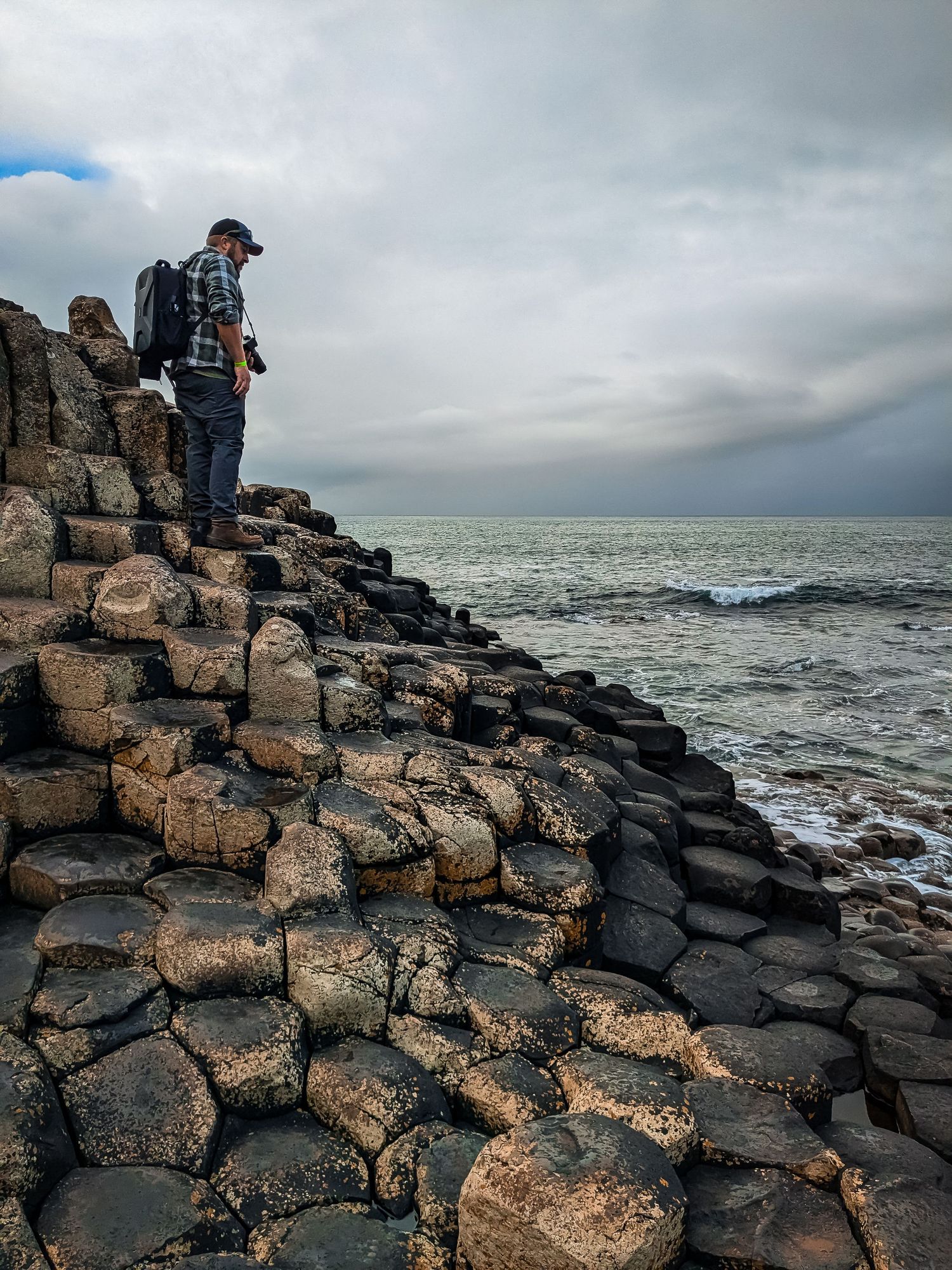 A photographer ontop of Giant's Causeway rocks
