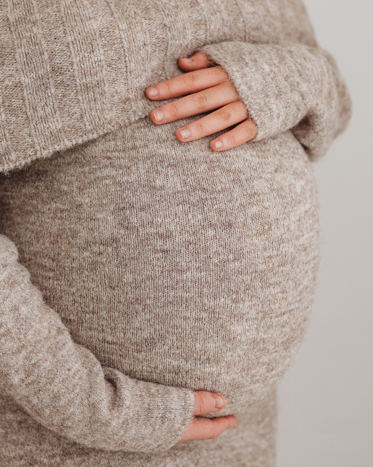close up of first time mum cradling her bump during her maternity session in Ayrshire