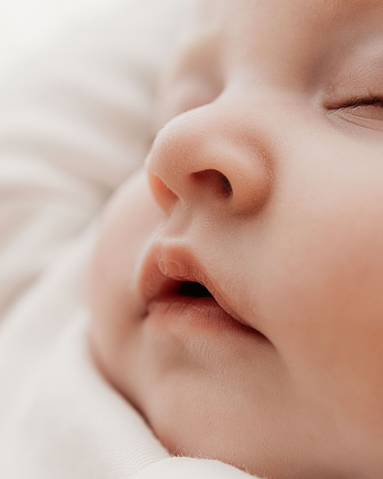 3 month old baby sleeps soundly, her beautiful features captured natural and timelessly by Faye McRae in her Ayrshire studio