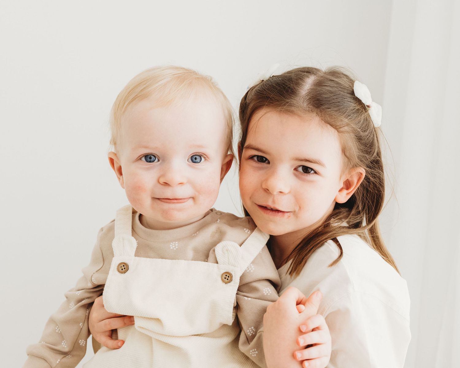 timeless sibling portrait captured in Faye McRae's natural all-white photography studio in Ayrshire