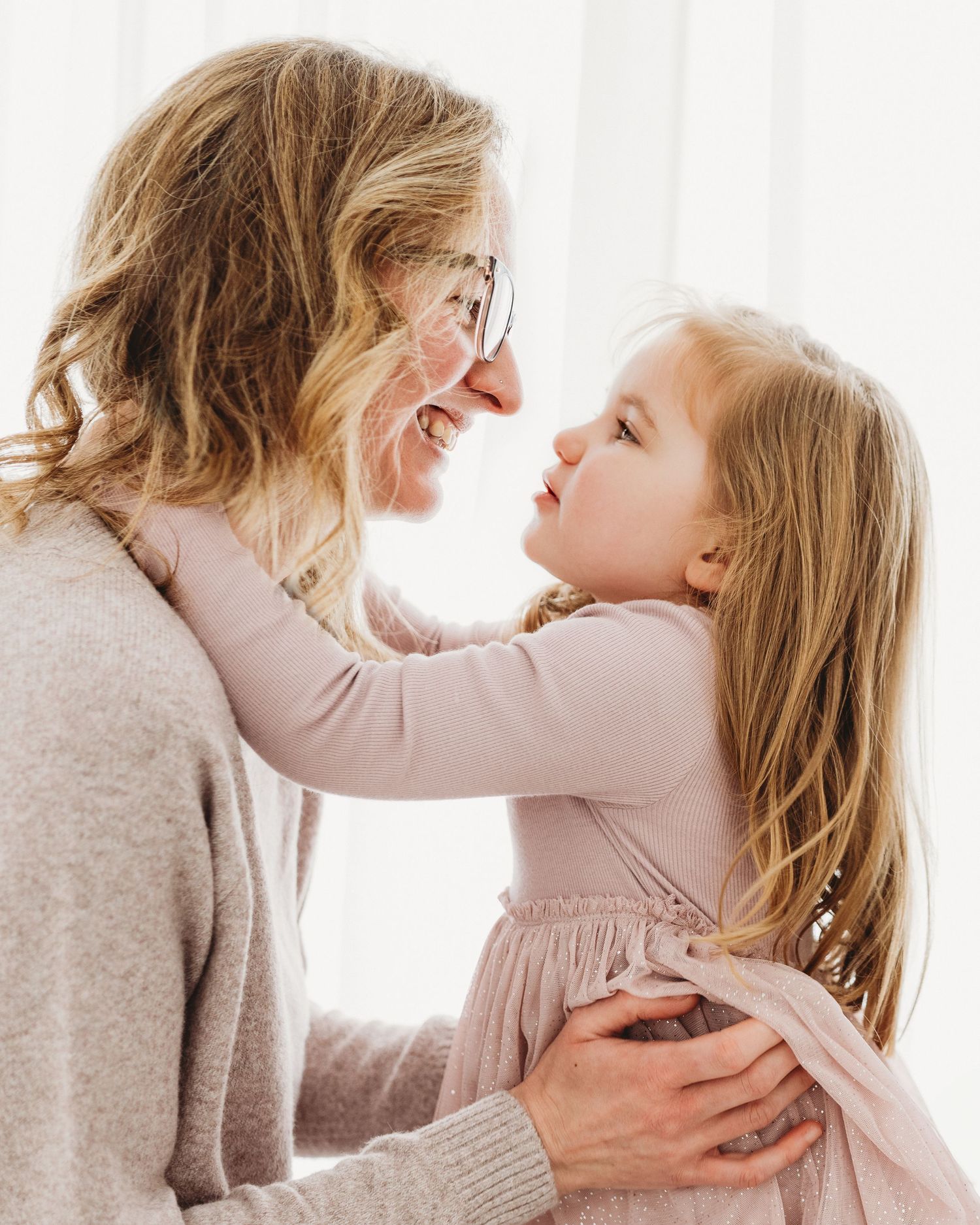 a tender moment between toddler girl and her mum as they look into each others eyes